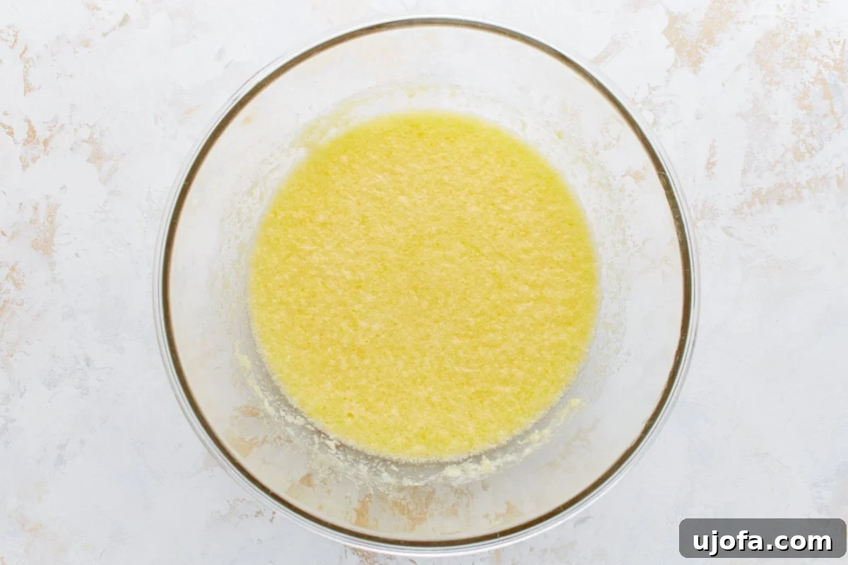 Wet ingredients, including lemon zest and butter, combined in a mixing bowl.