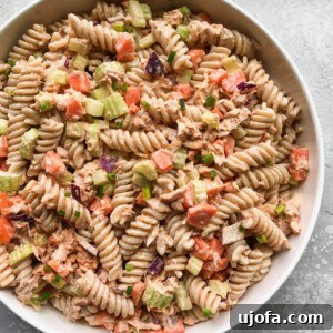 Finished Buffalo Tuna Pasta Salad in a bowl, garnished with fresh herbs.