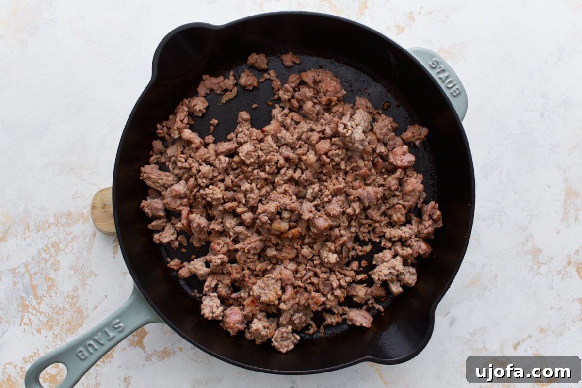 Creamy Gluten-Free Sausage Gravy 5 Perfectly browned and crumbled gluten-free breakfast sausage in a cast iron skillet, with just enough fat rendered, ready for the next step of making creamy gravy.