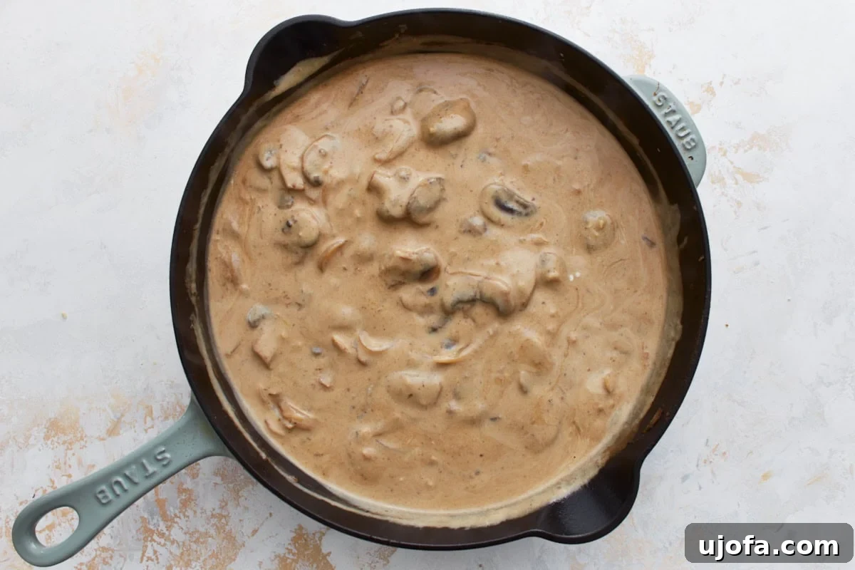 Sour cream stirred into the thickened mushroom sauce, giving it a creamy consistency.