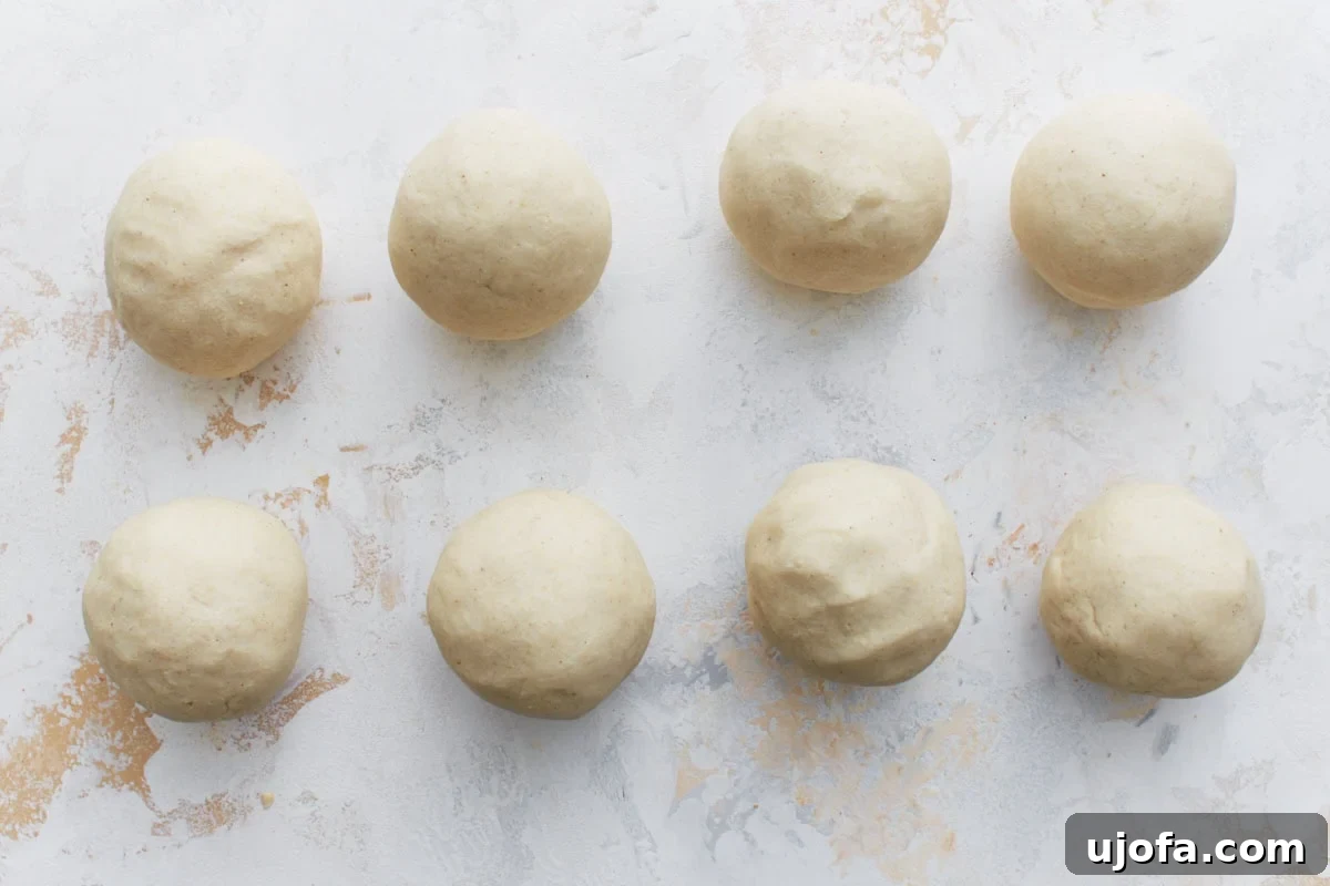 Savory Salvadoran Pockets 6 Eight evenly portioned dough balls arranged on a light surface, ready to be shaped into pupusas.