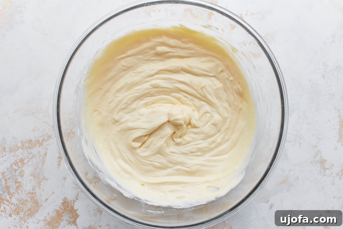 Decadent Keto Cheesecake 9 Keto cheesecake filling after eggs, vanilla, lemon juice, and sour cream have been mixed in.