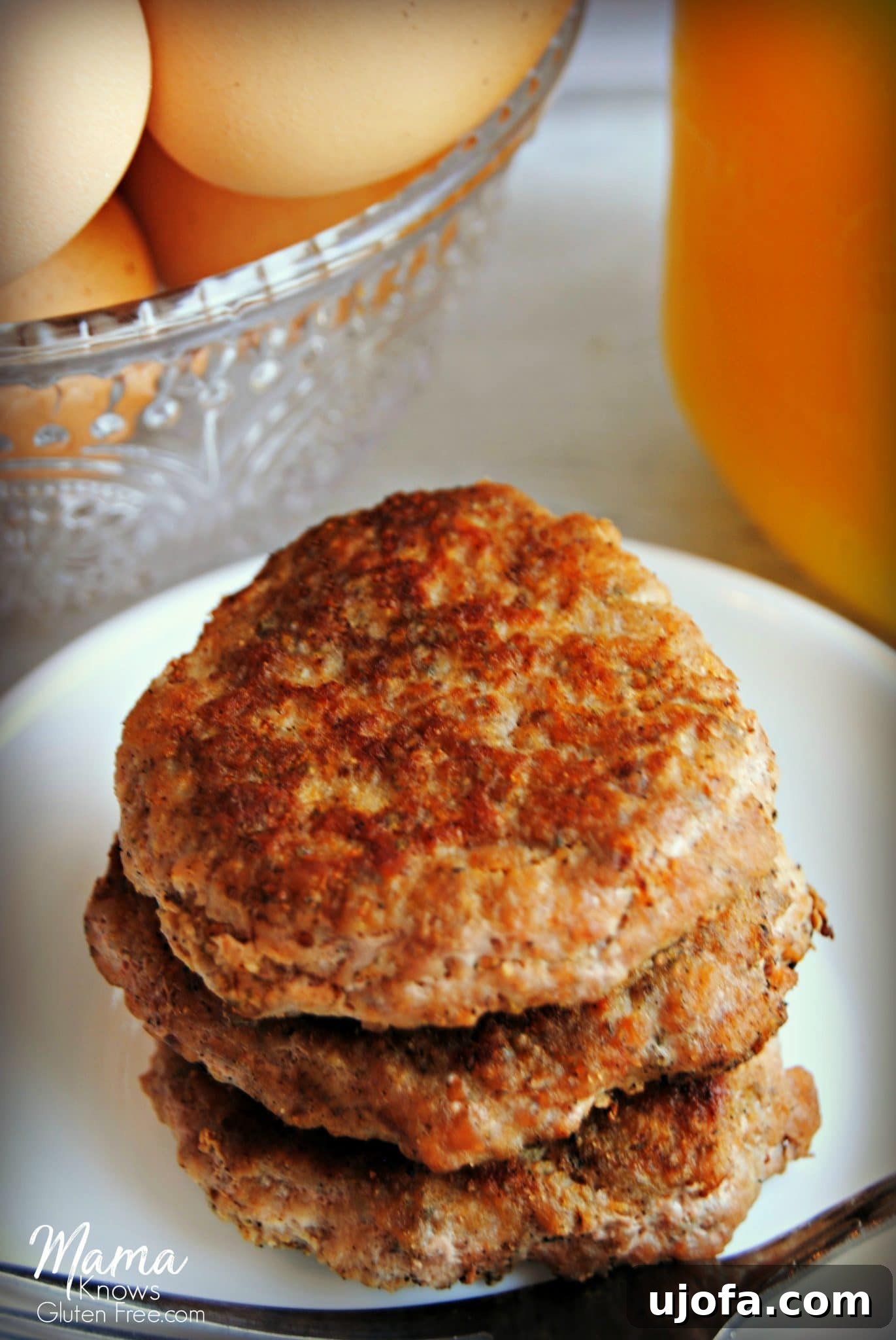 Healthy Homemade Turkey Breakfast Sausage Patties with fresh herbs on a wooden board