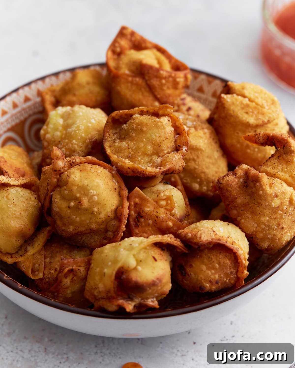 Crispy golden gluten-free crab rangoons with creamy filling, served on a plate ready to eat.