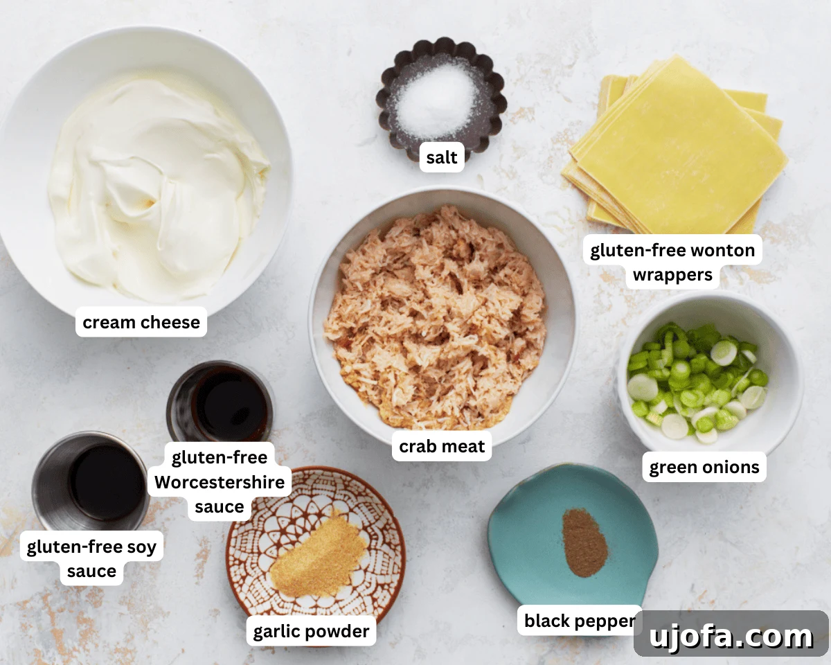 A collection of fresh ingredients laid out for making gluten-free crab rangoon: cream cheese, crab meat, green onions, and spices.