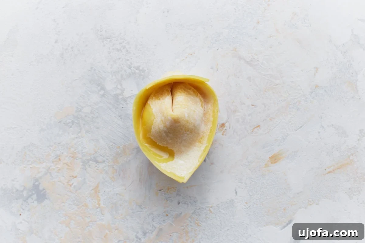 A folded gluten-free crab rangoon, showing the securely sealed edges.