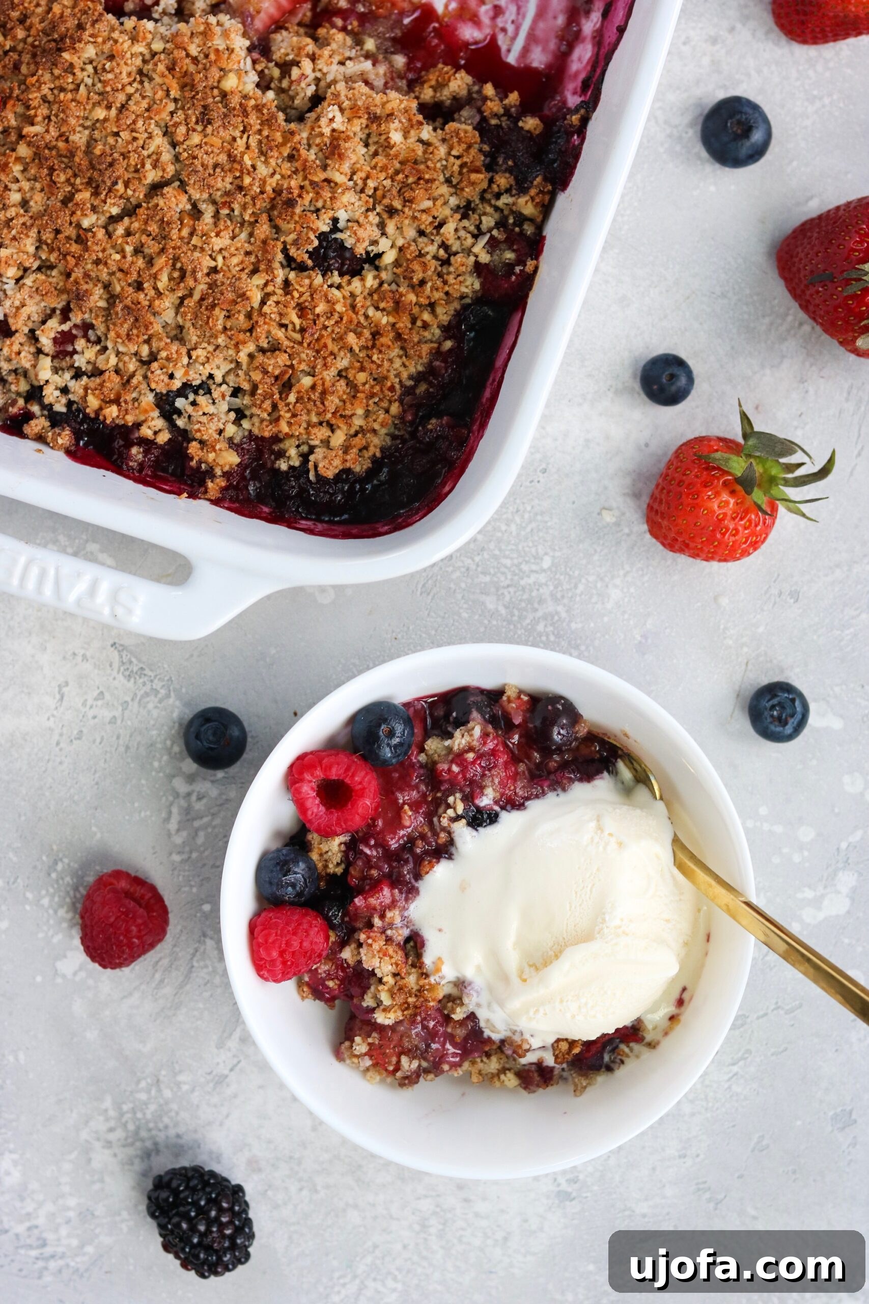 Paleo Vegan Berry Crumble 4 Close-up of baked Paleo Vegan Berry Crisp with a scoop of coconut ice cream