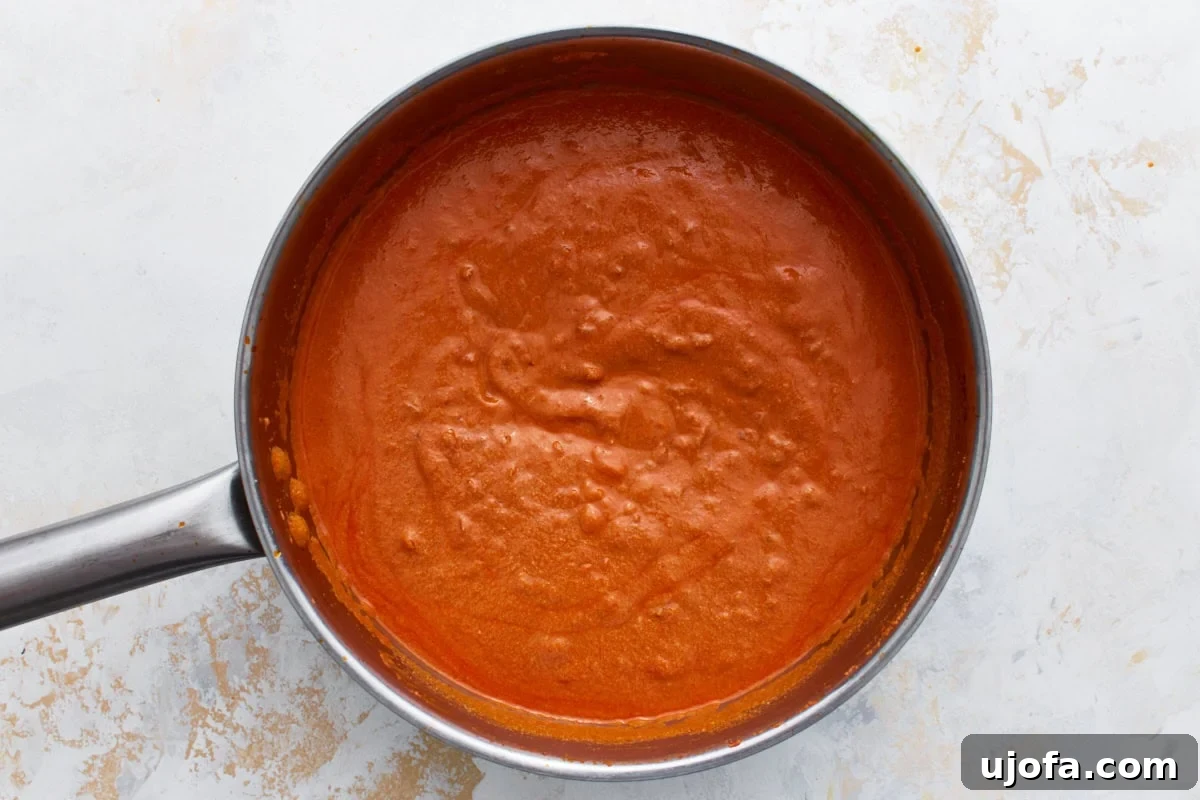 Vegan vodka sauce blended smooth and creamy, simmering in a skillet.