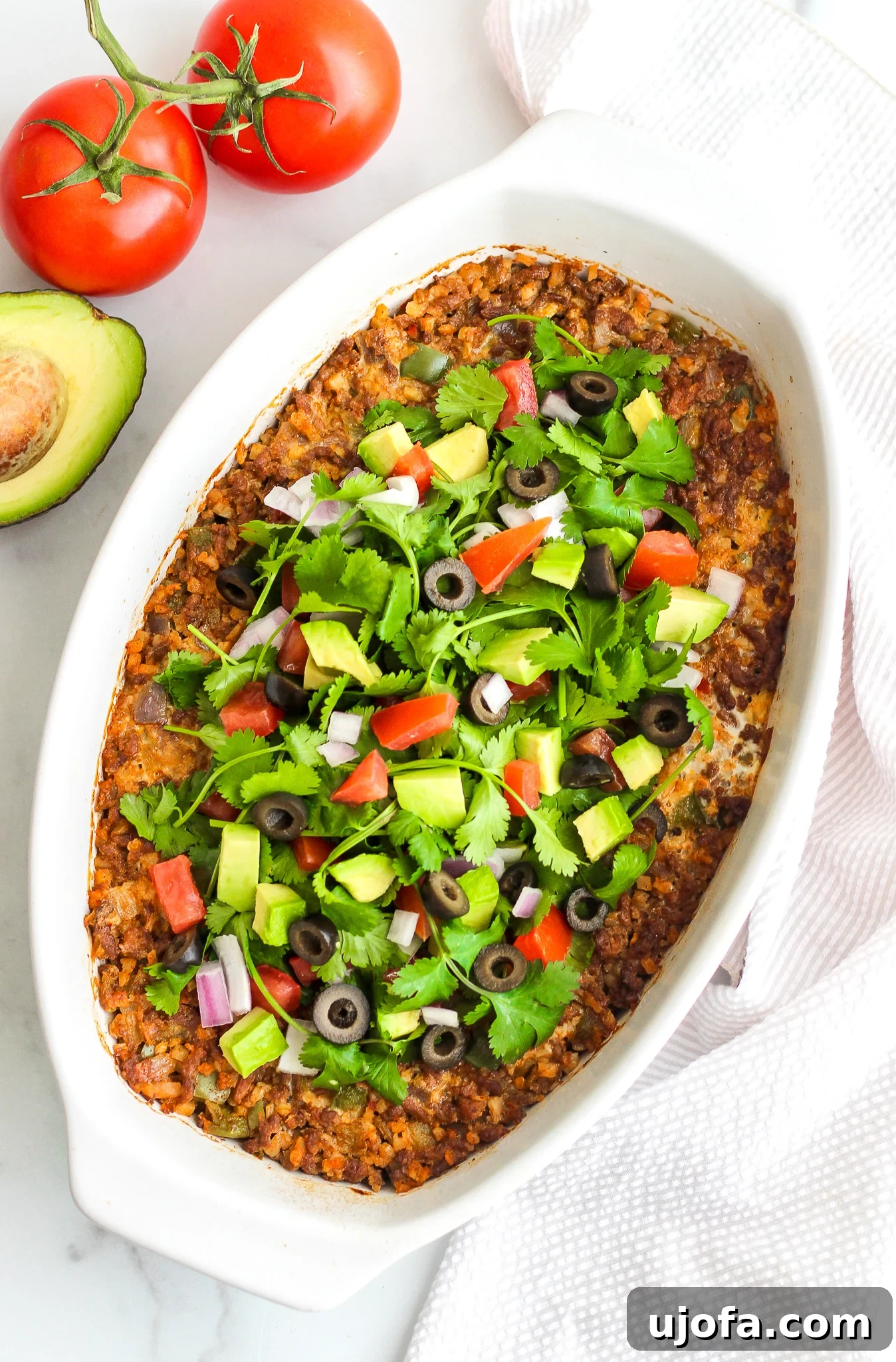 Fiesta-Ready Whole30 Paleo Mexican Meals 9 Whole30 and Keto Taco Bake, golden brown and bubbly, garnished with fresh cilantro.