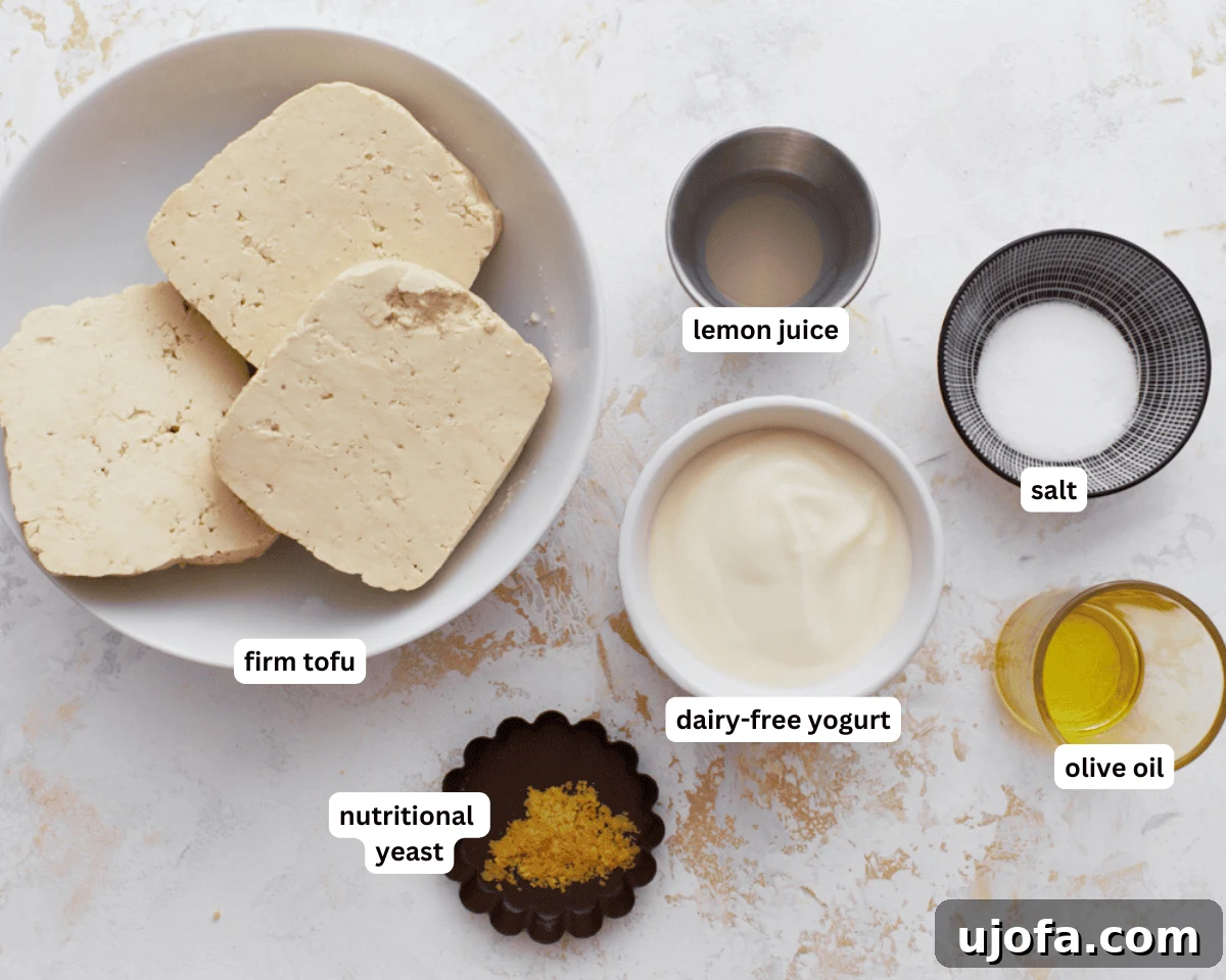 Vegan Farmhouse Curds 4 Dairy-free cottage cheese ingredients including firm tofu, dairy-free yogurt, lemon juice, olive oil, salt, and nutritional yeast arranged on a white surface.