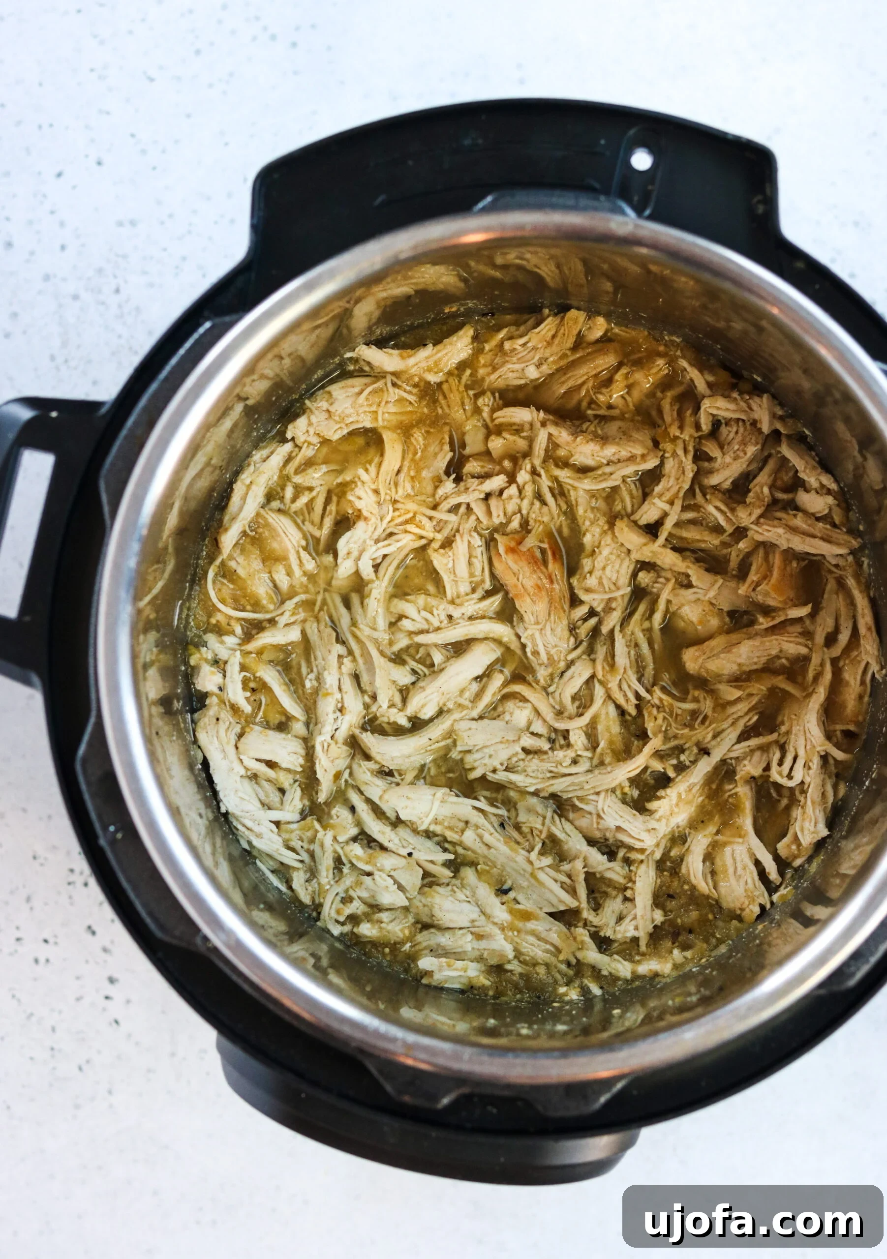 Effortless Whole30 Instant Pot Salsa Verde Chicken 2 Delicious Whole30 Instant Pot Salsa Verde Chicken ready to be served in a bowl with fresh toppings.