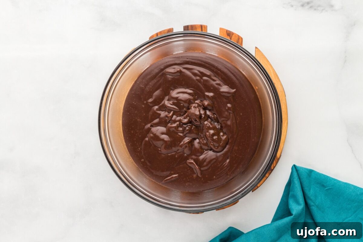 Warm pudding poured into a glass mixing bowl, ready to chill and set.