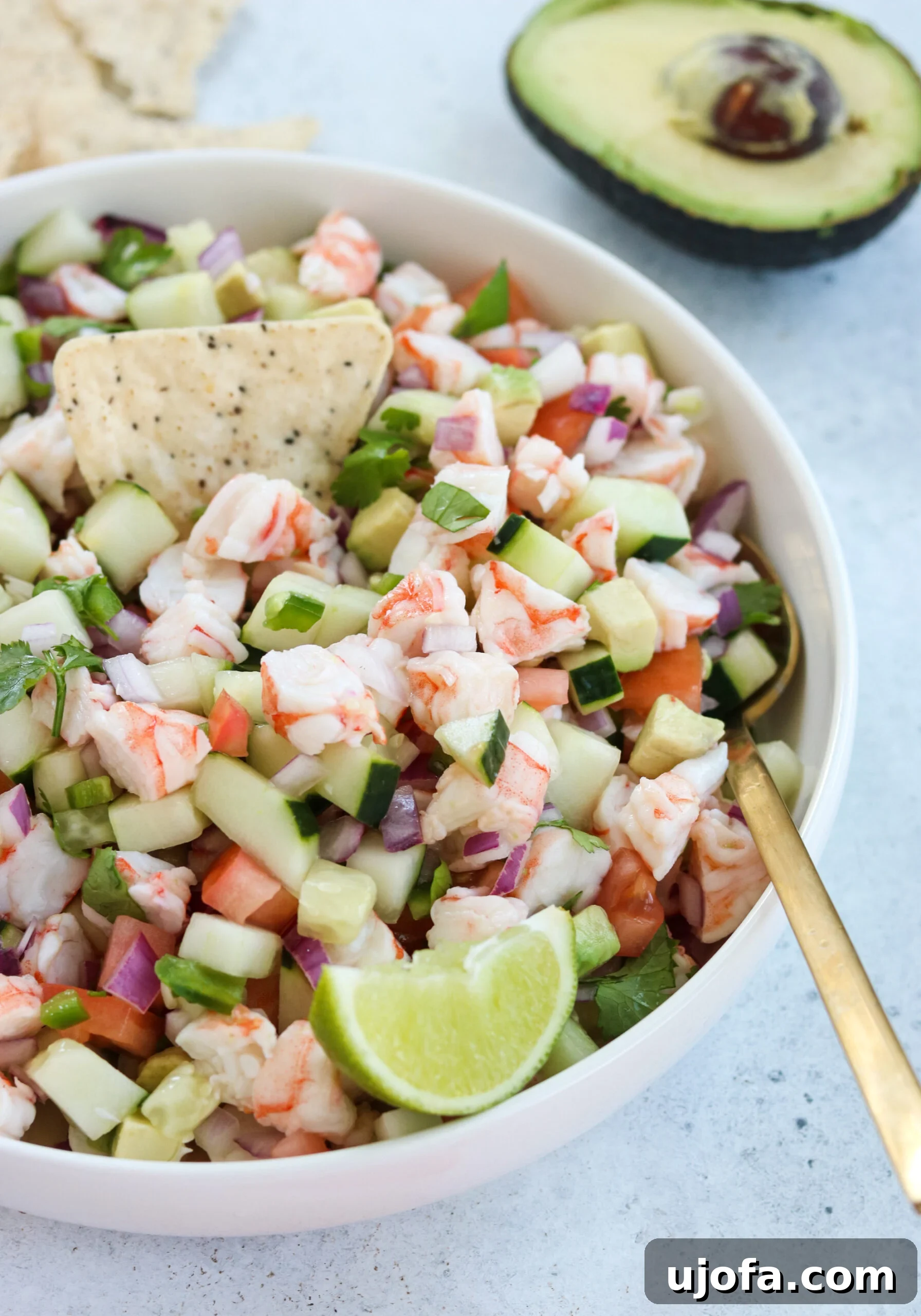 A bowl of vibrant Easy Shrimp Ceviche, garnished with fresh cilantro and lime wedges, ready to be served.