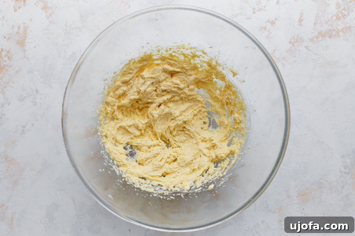 Butter, sugar, egg, and vanilla mixed together until smooth for almond flour sugar cookies.