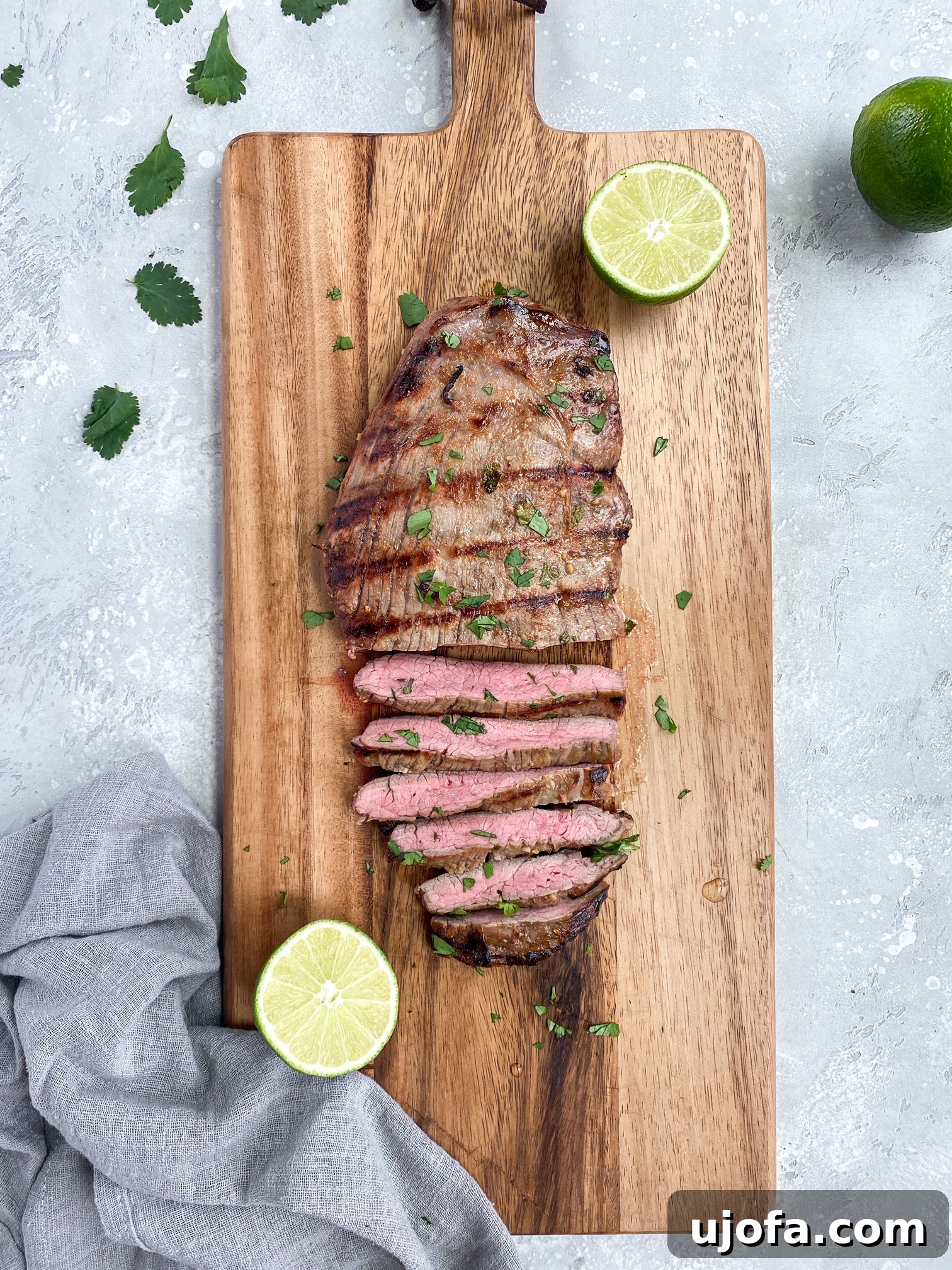 Close-up of marinated Whole30 Carne Asada flank steak ready for grilling