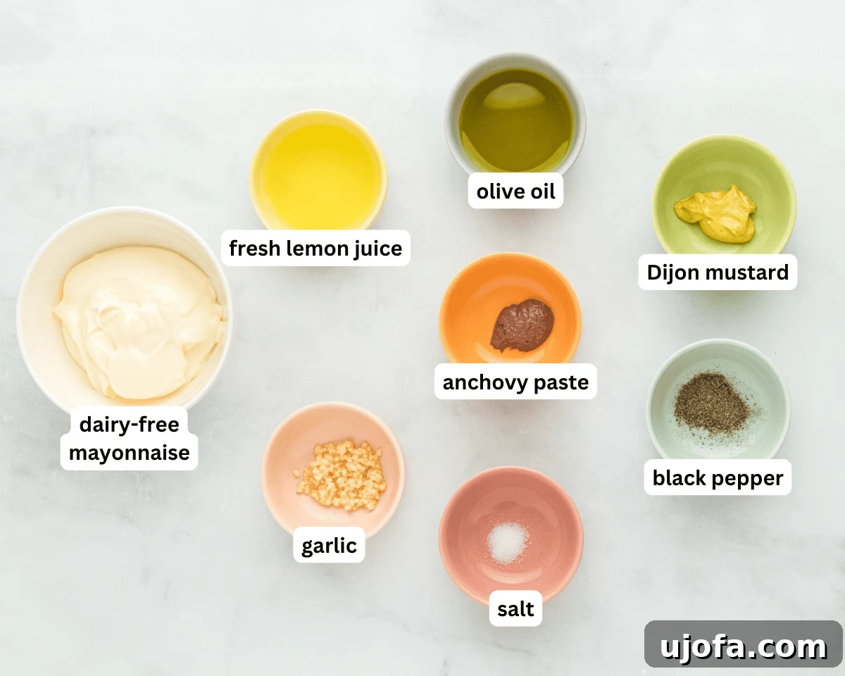 Creamy Dairy-Free Caesar Dressing 4 Dairy-free caesar dressing ingredients laid out neatly on a wooden board