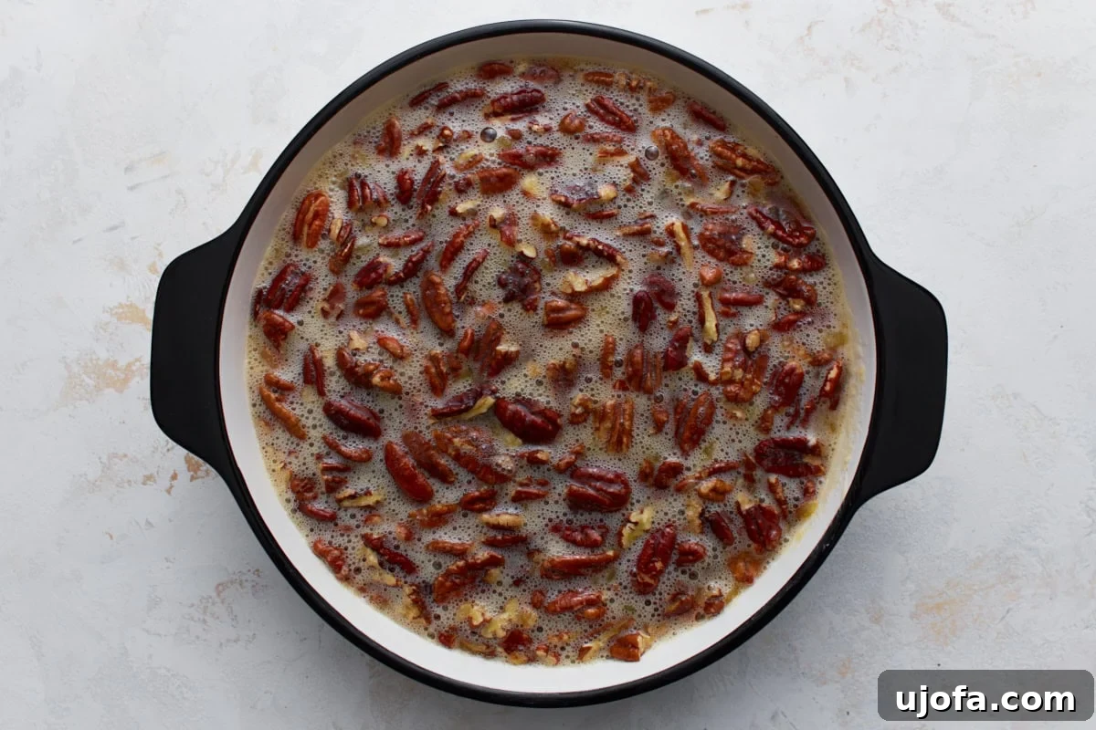 Crust Free Pecan Perfection 7 The pecan pie mixture, rich with whole pecans, poured into a greased ceramic pie dish, ready for baking.