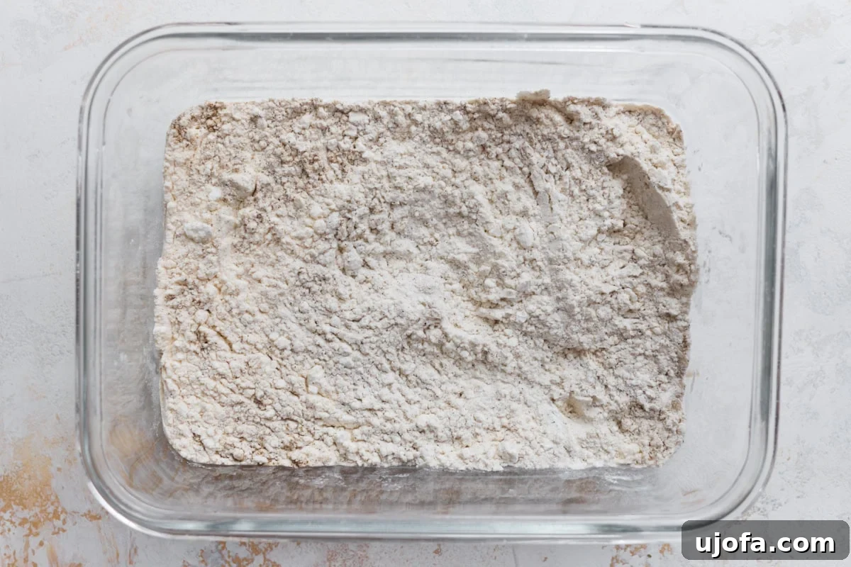 Cornstarch and gluten-free flour mixture for coating chicken in a glass baking dish