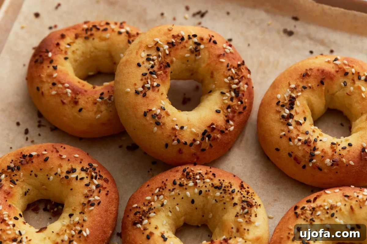 Perfect Keto Bagels 14 Golden brown keto bagels with a soft, doughy texture, topped with everything bagel seasoning.