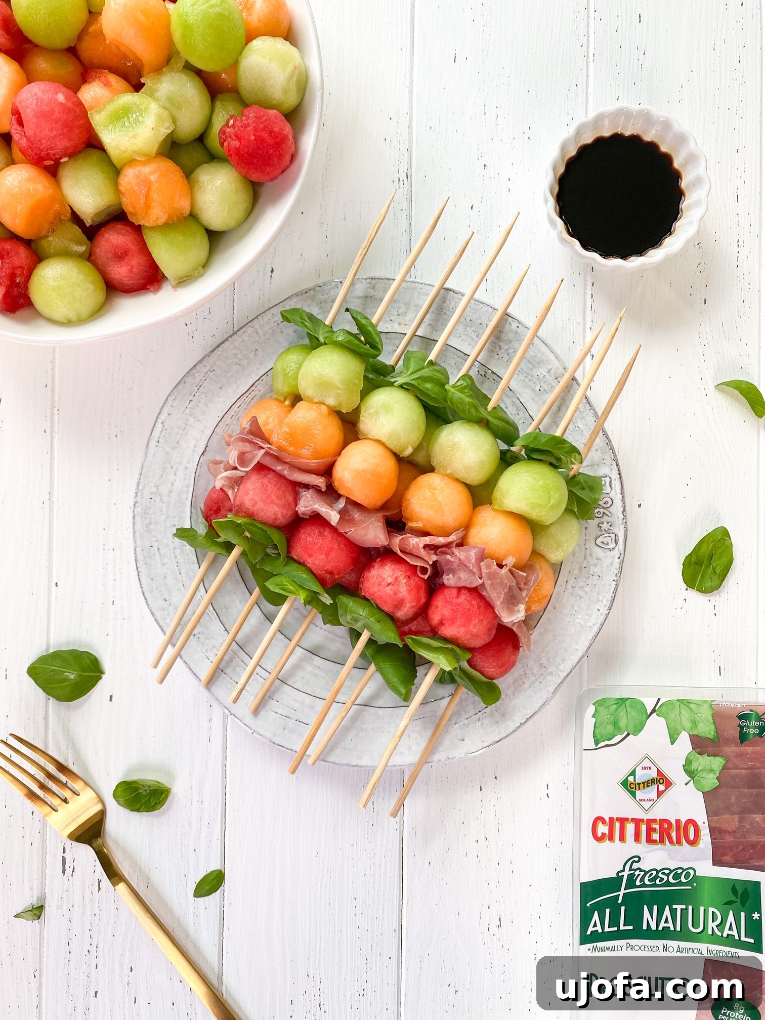 Whole30 Sweet and Savory Melon Prosciutto Skewers 2 Colorful Whole30 Melon Basil Prosciutto Skewers on a white plate, ready to serve.