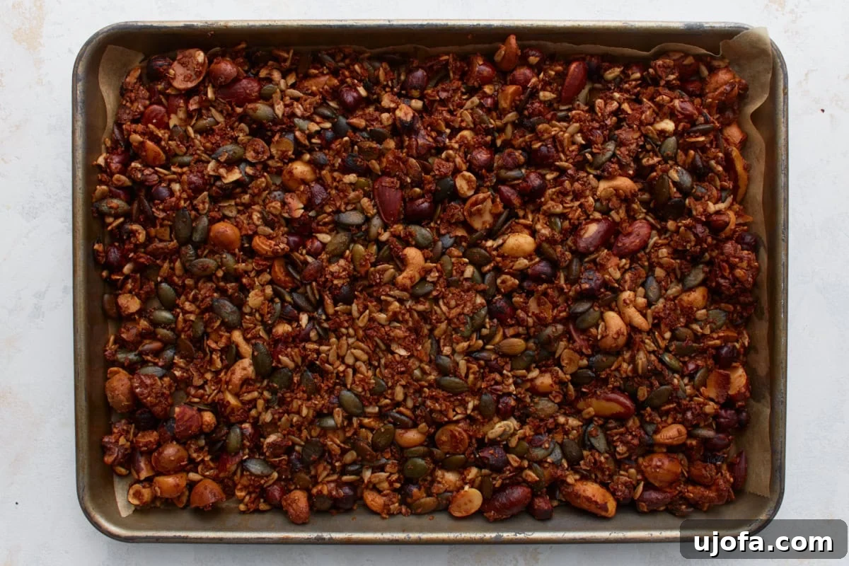 Ketogenic Granola Clusters 8 Freshly baked keto granola on a baking sheet, lightly golden and crisp after cooling, with visible clusters.