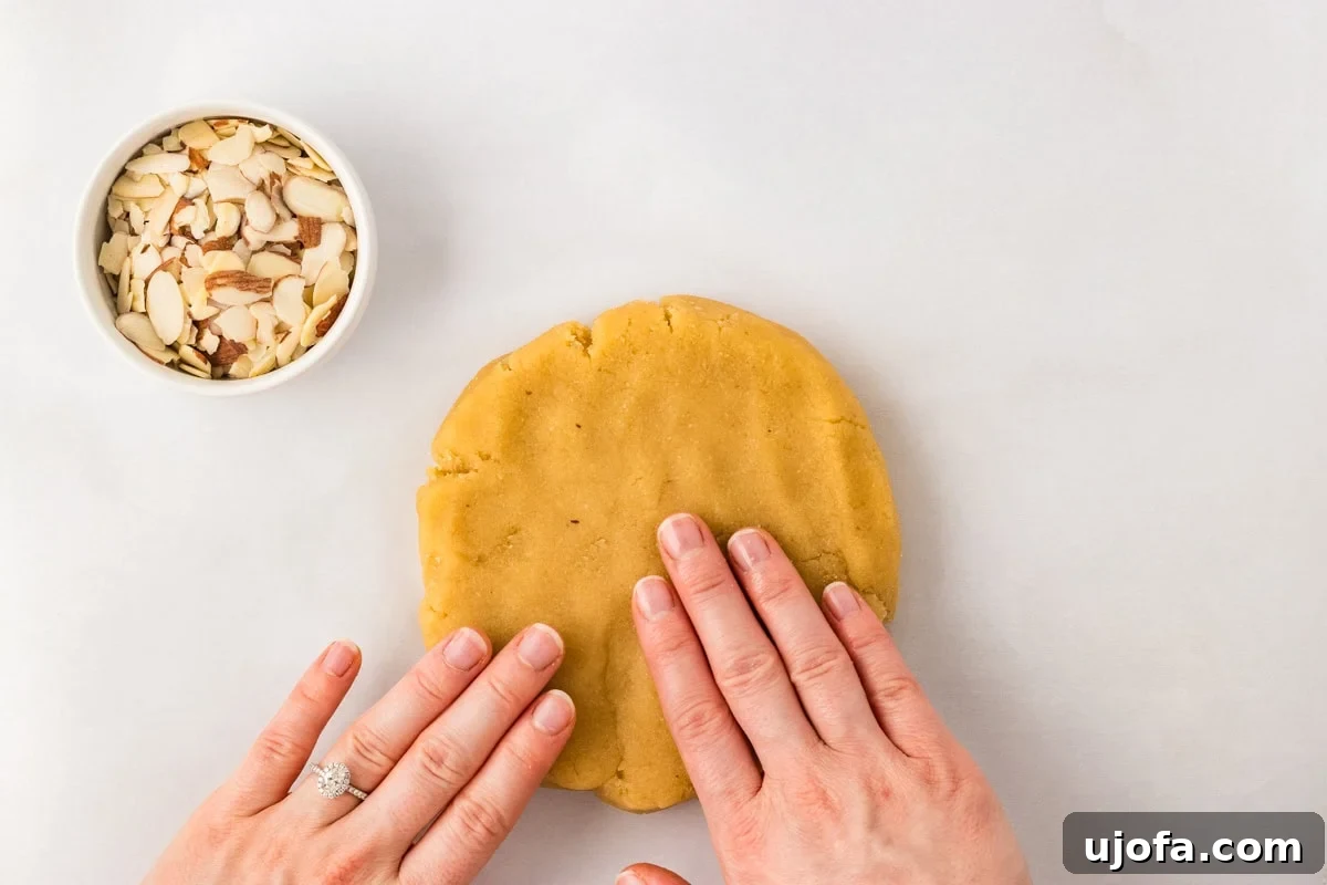 Tender Almond Scones 10 Hands pressing almond flour scone dough into thick disc before cutting