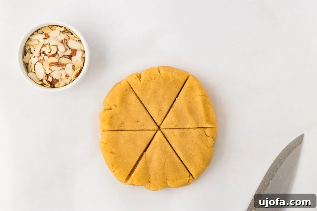 Tender Almond Scones 11 Almond flour scone dough shaped into thick disc and cut into 6 triangles with knife