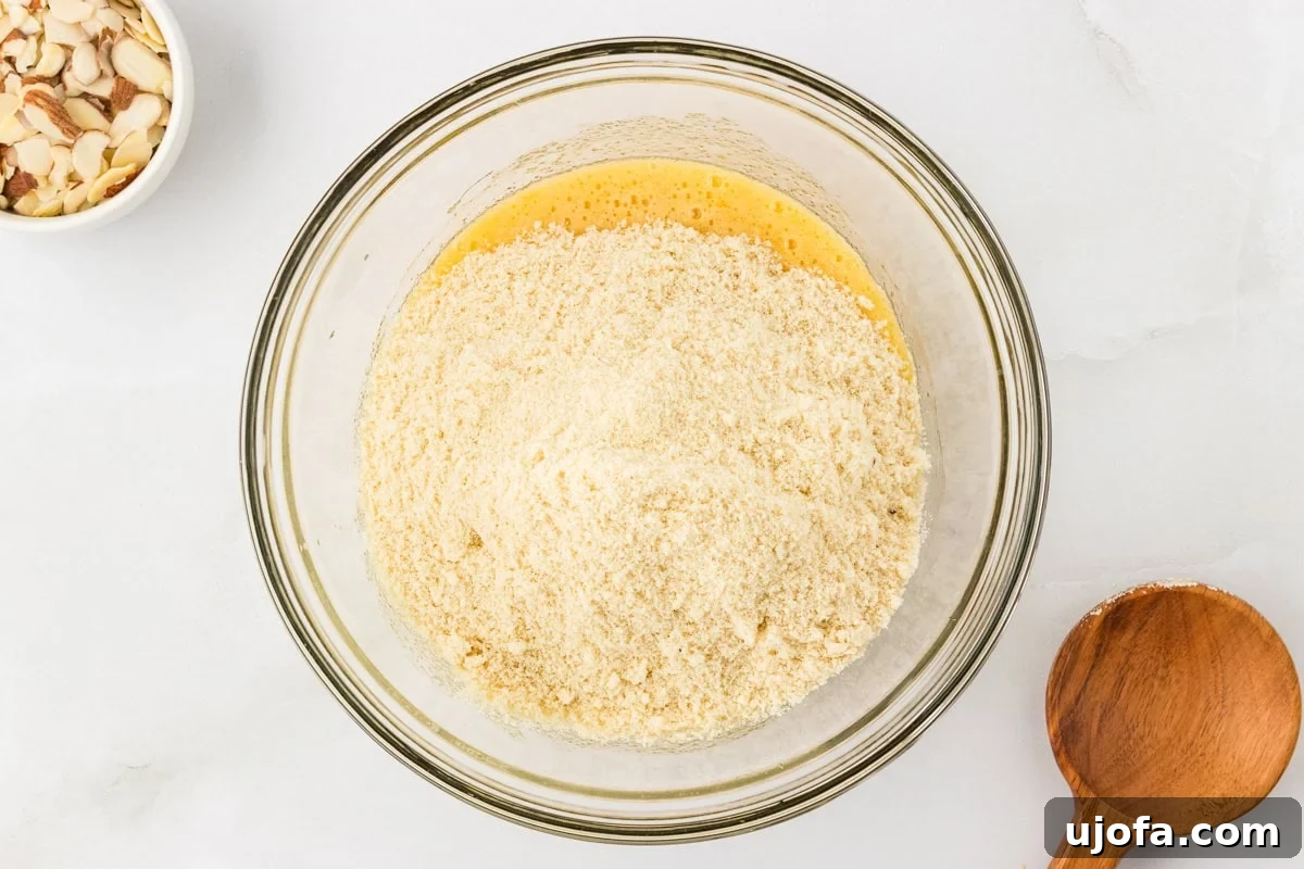 Tender Almond Scones 7 Almond flour mixture added to wet ingredients in glass mixing bowl