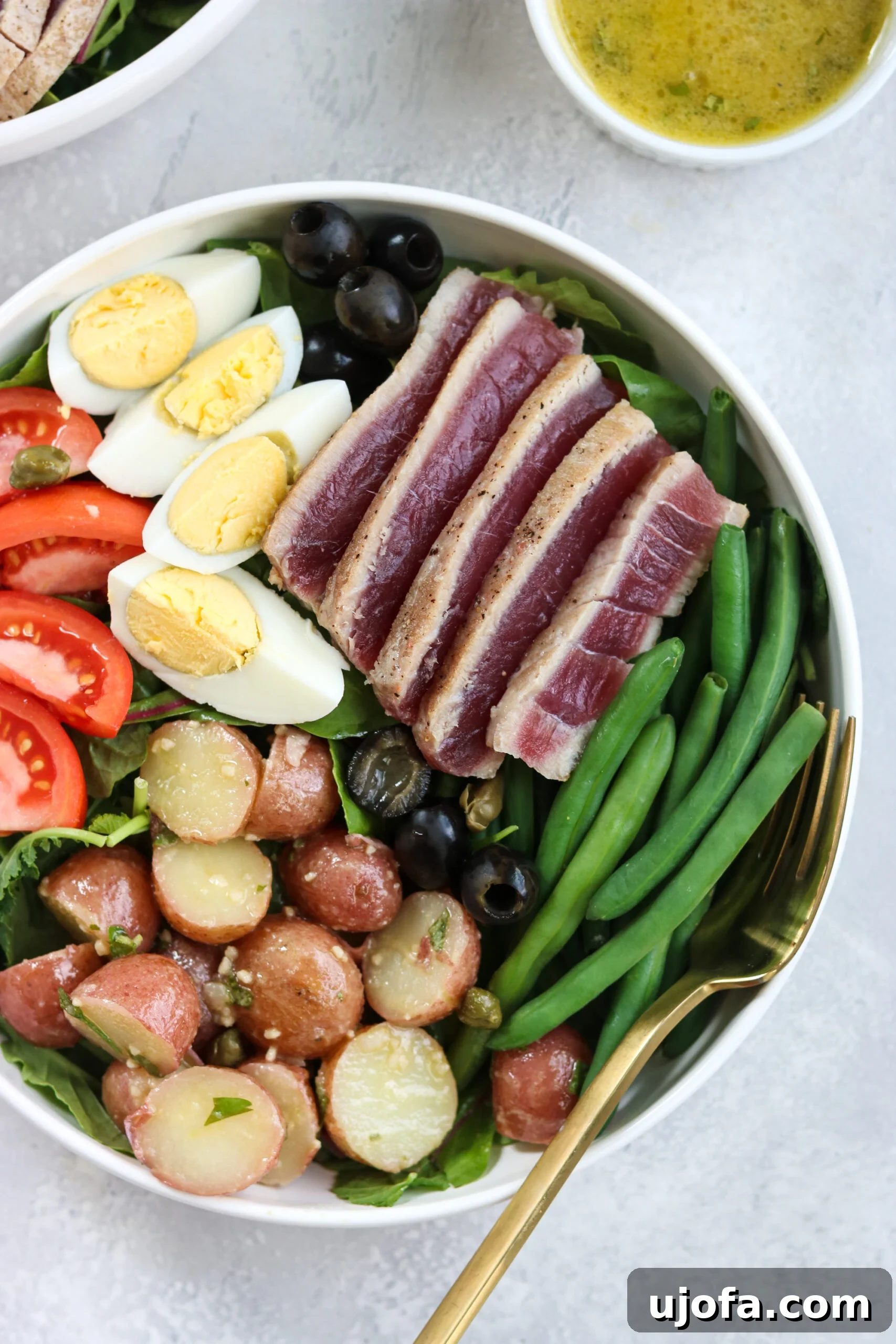 Freshly plated Whole30 Nicoise Salad with seared Ahi Tuna, eggs, and vibrant vegetables