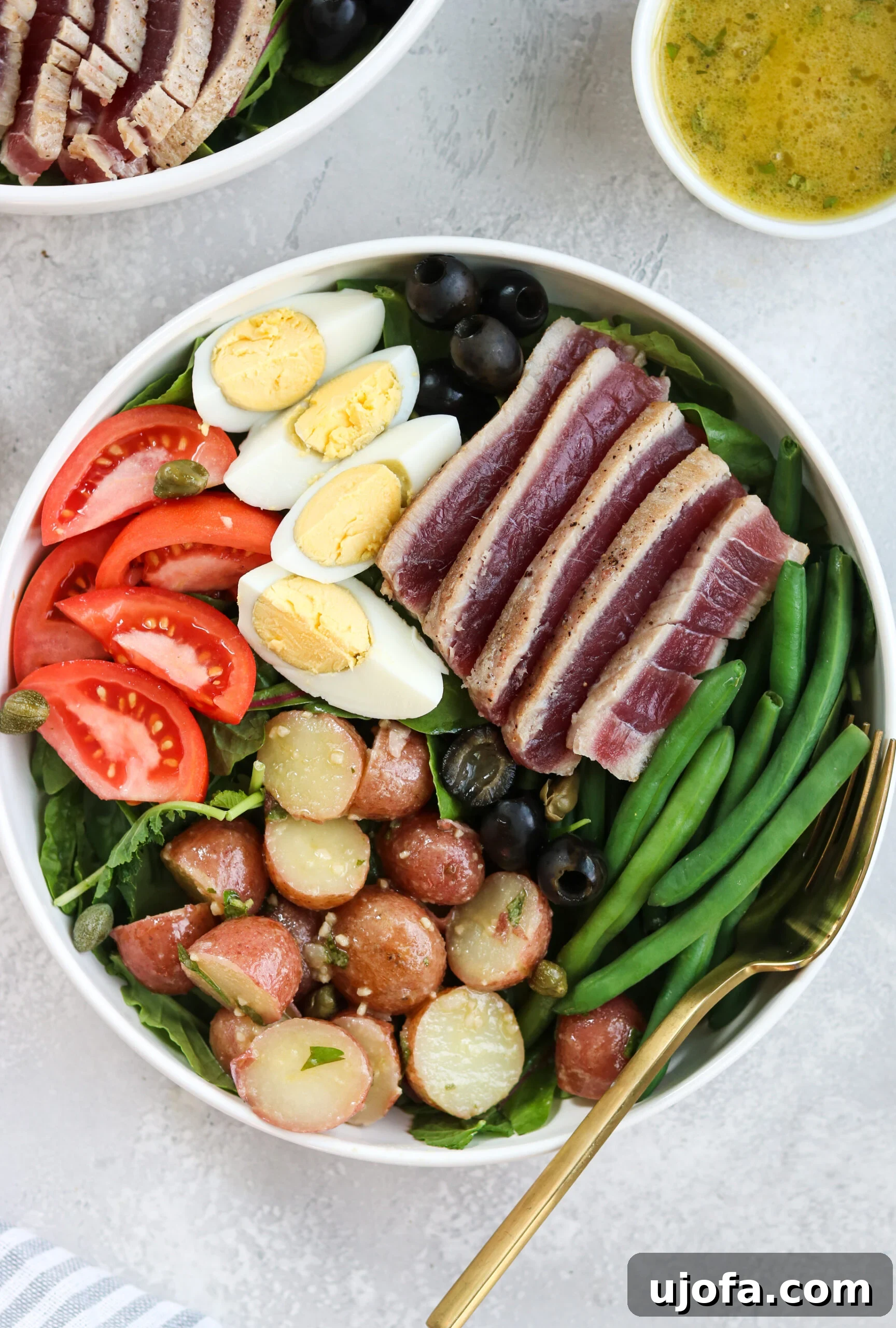 A bowl of fresh Champagne Vinaigrette, ready to dress the Whole30 Nicoise Salad