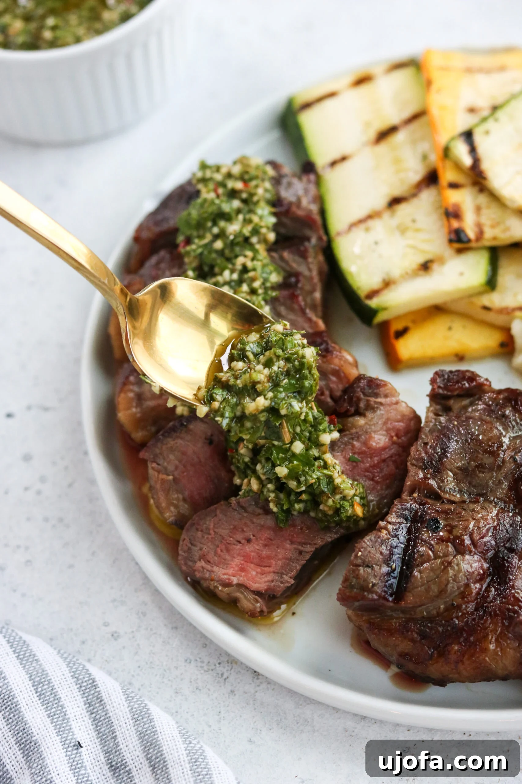 A close-up shot of grilled New York Strip steaks, perfectly seared with grill marks, resting on a cutting board, ready to be sliced and served.