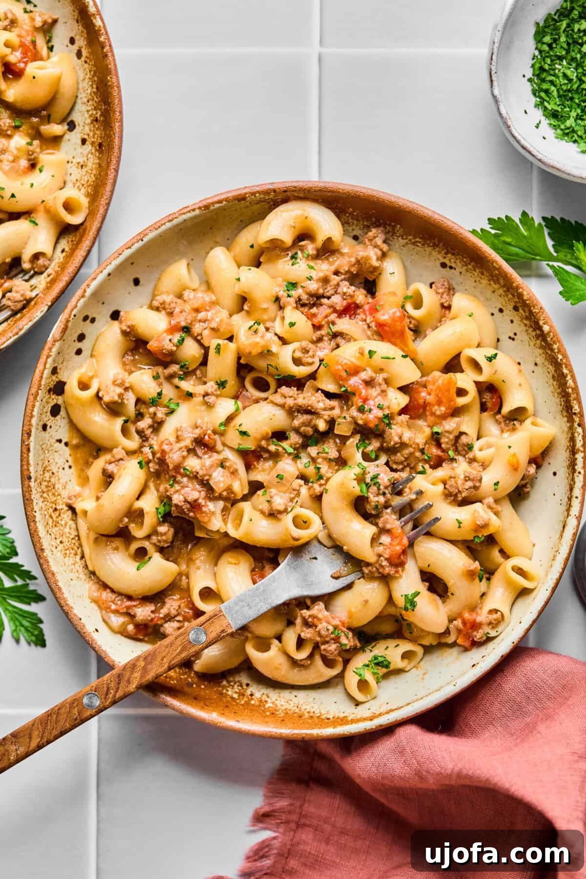 A comforting bowl of gluten-free hamburger helper with a fork, ready to be enjoyed.