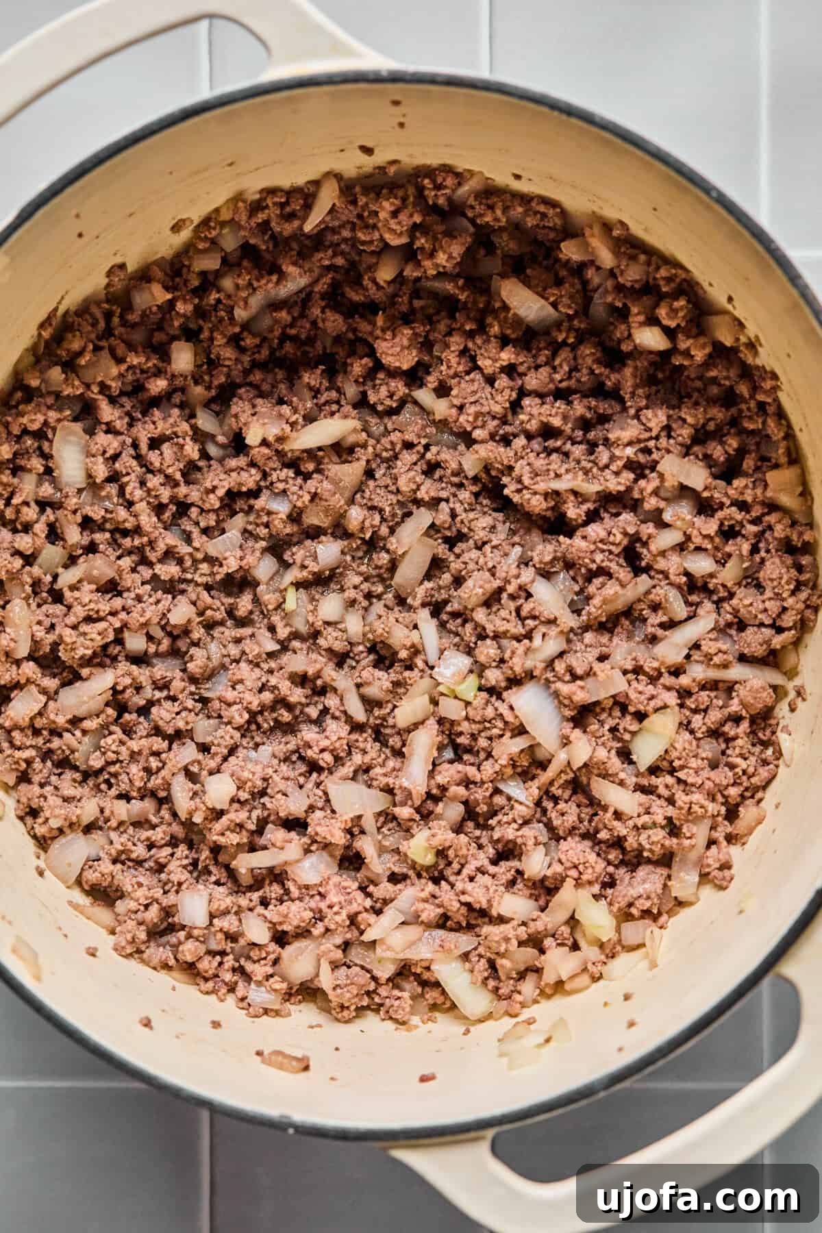 Sautéing ground beef and onions in a large skillet for the gluten-free hamburger helper.