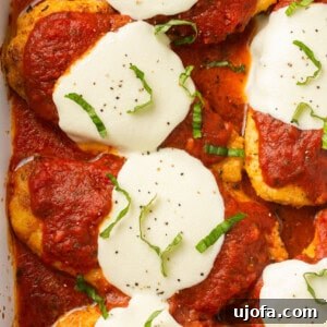 gluten free chicken parmesan in a casserole dish topped with basil