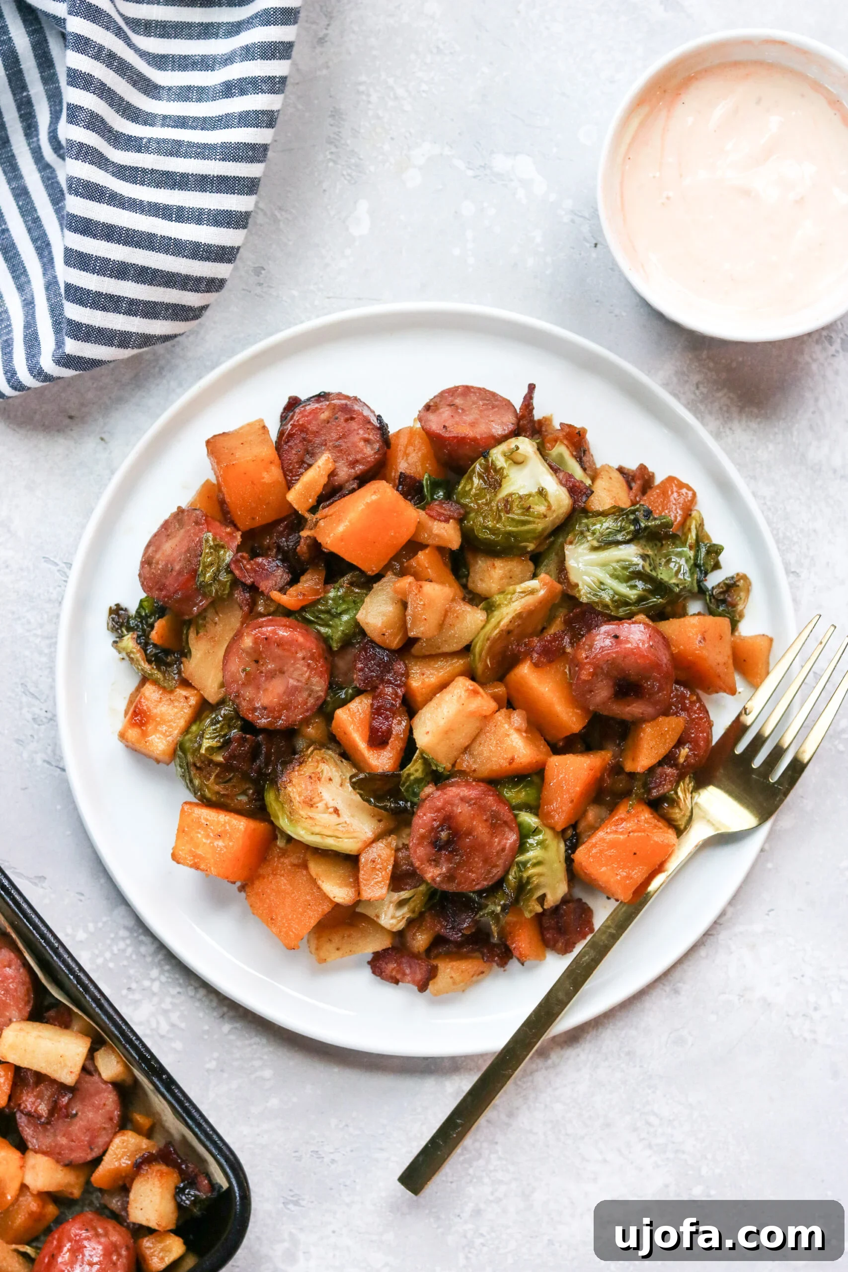 Cooked Whole30 Harvest Sheet Pan Dinner, showcasing the final golden-brown vegetables and crispy bacon.