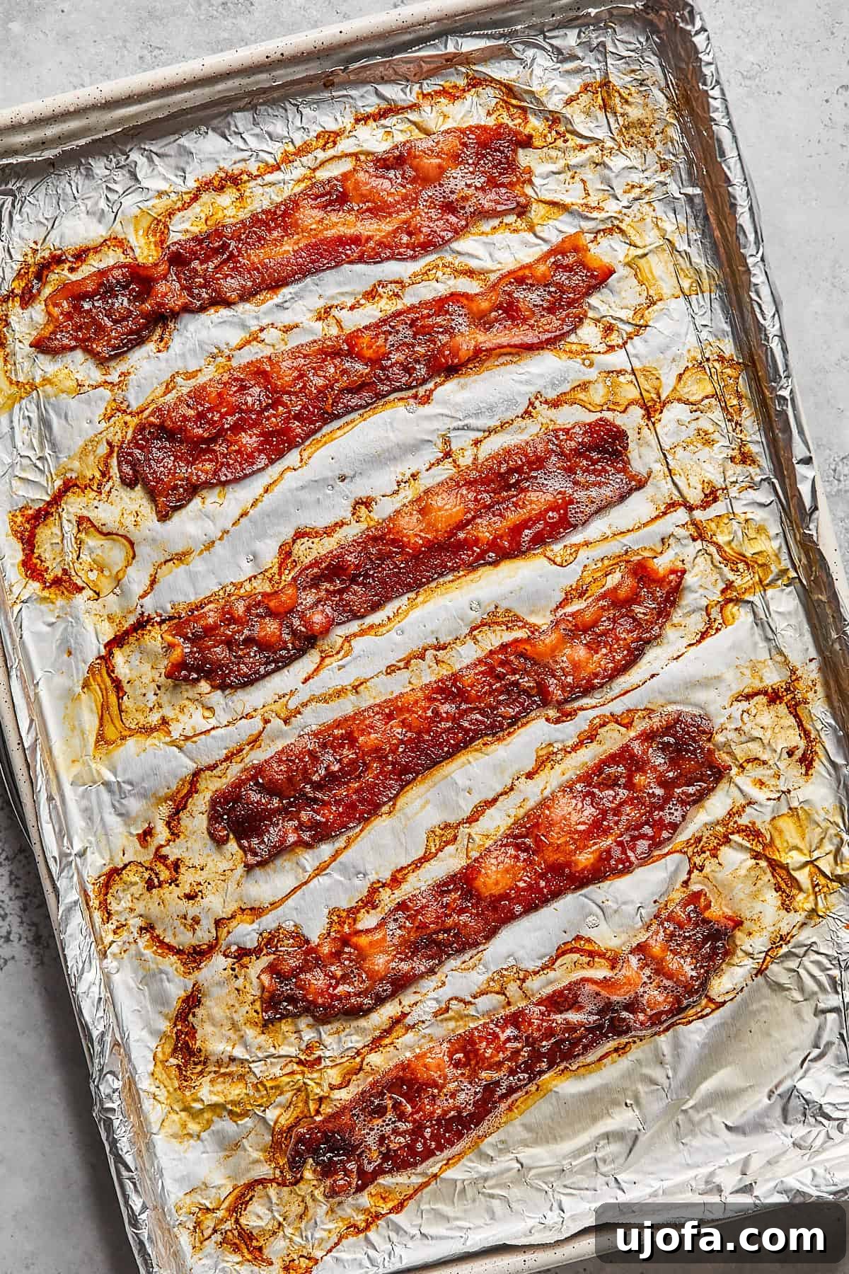 Creamy Dairy-Free Bacon Cheeseburger Soup 4 Crispy strips of cooked bacon resting on a foil-lined baking sheet, ready to be crumbled for the soup.