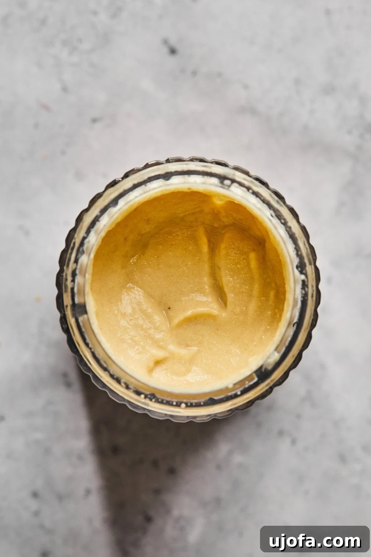 Creamy Dairy-Free Bacon Cheeseburger Soup 8 A small jar containing smooth, creamy cashew cheese sauce, ready to be added to the soup.