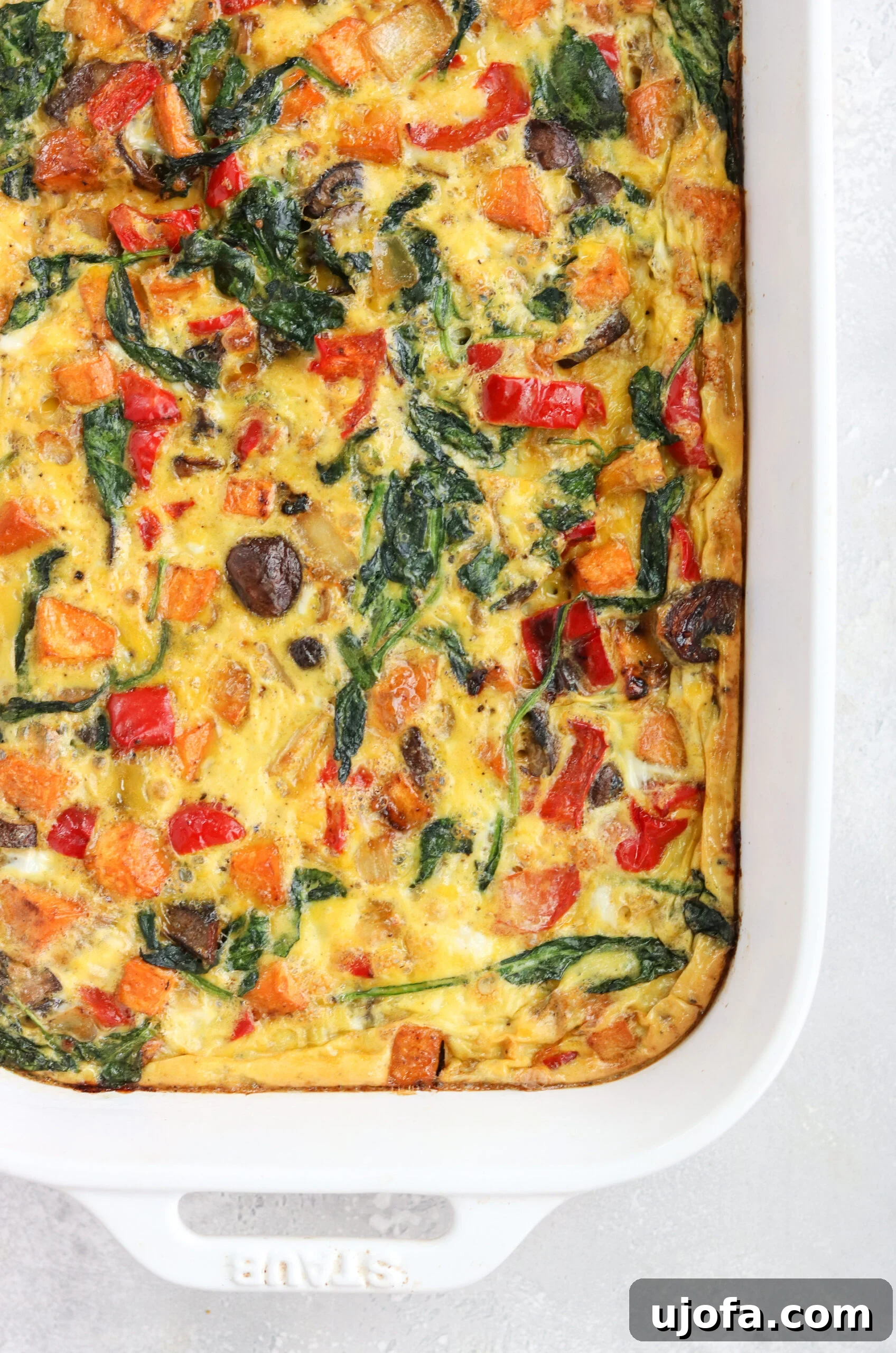 Wholesome Roasted Vegetable Breakfast Bake 4 A bowl of flavorful marinade ingredients: olive oil, dijon mustard, coconut aminos, minced garlic, hot sauce, and onion powder.
