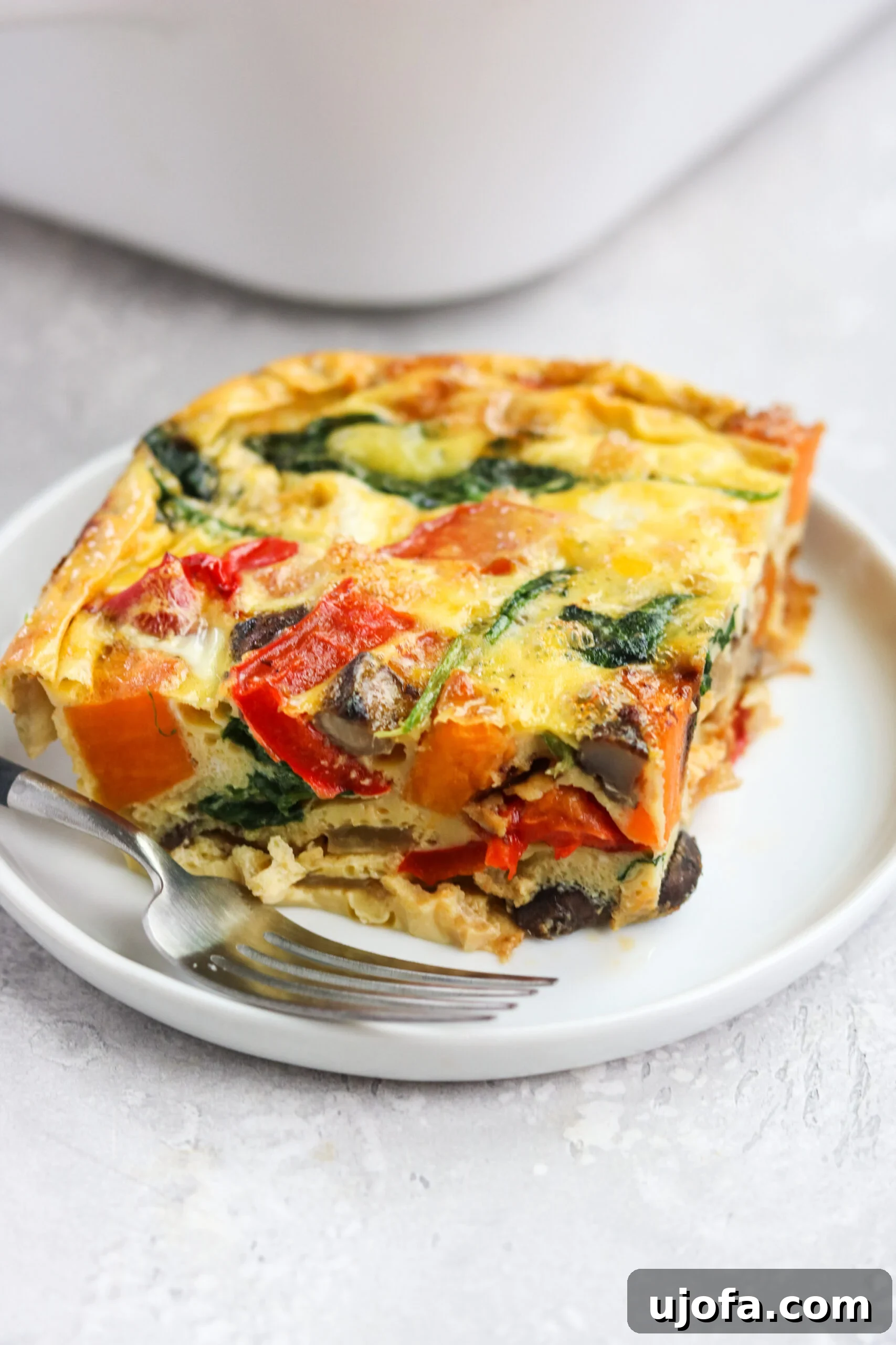 Wholesome Roasted Vegetable Breakfast Bake 5 A vibrant, healthy Roasted Veggie Breakfast Casserole, freshly baked and ready to be sliced, perfect for a nutritious morning.
