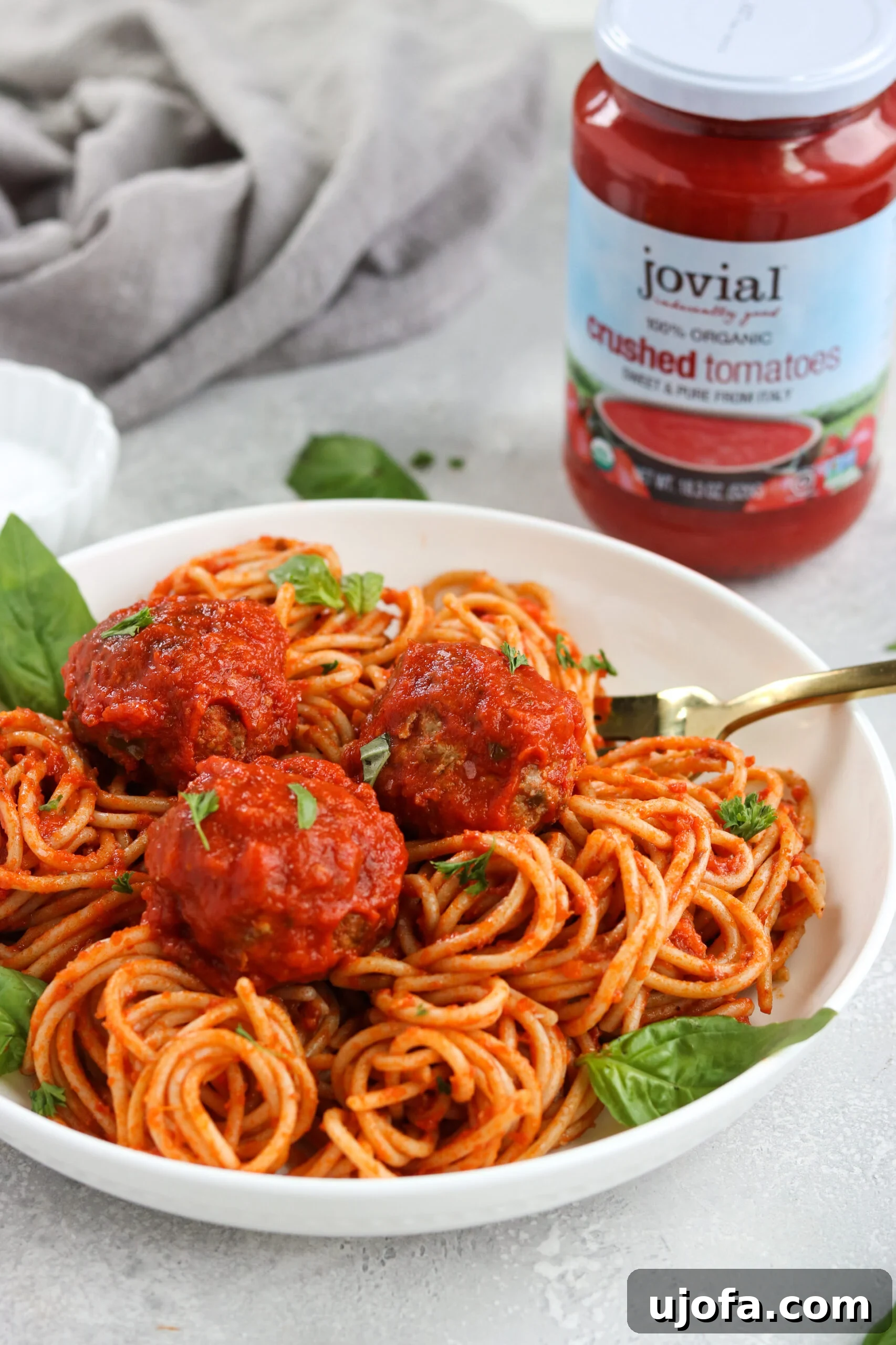 Close-up of Gluten Free Italian Meatballs simmering in rich Homemade Marinara sauce.