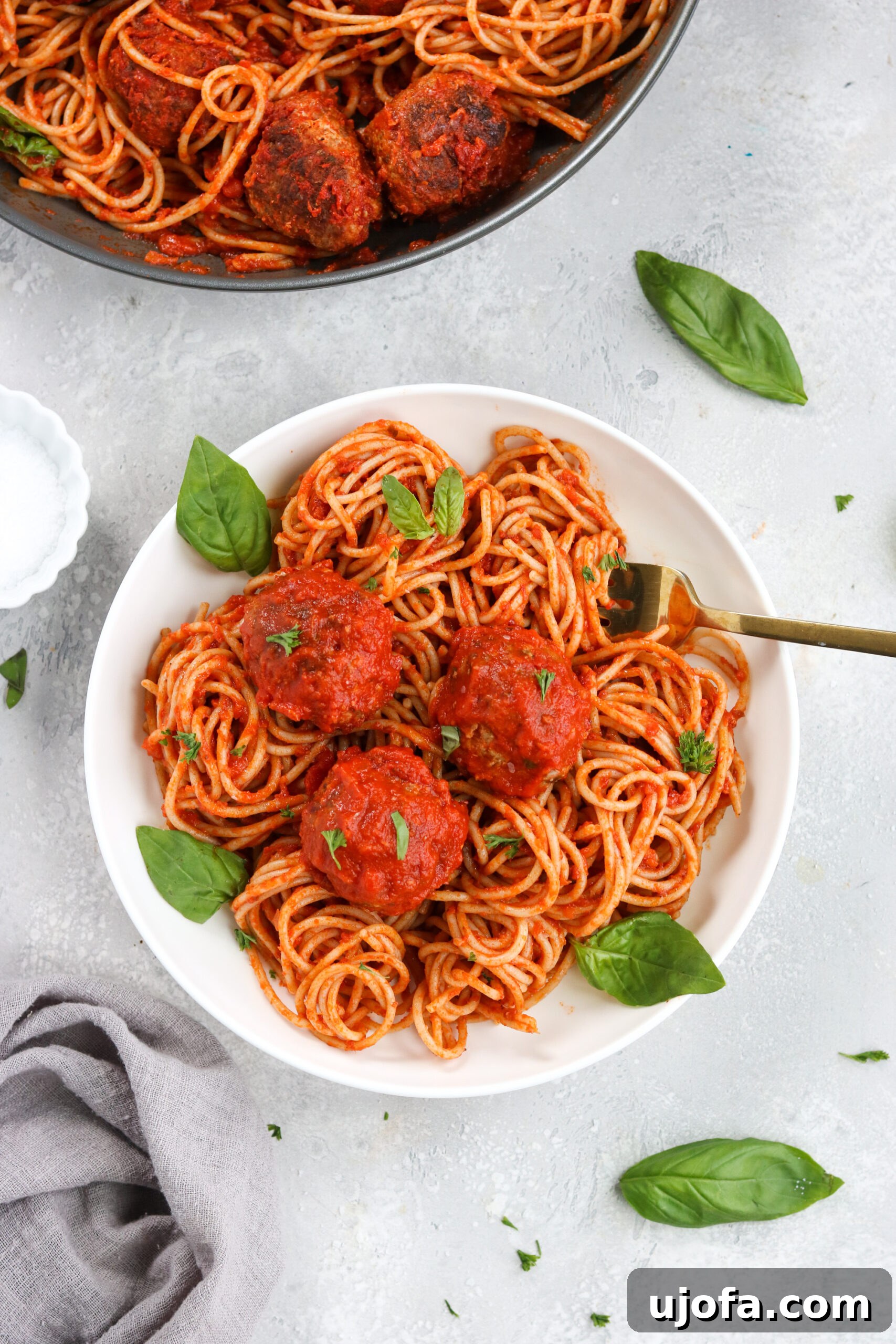 Plated Gluten Free Italian Meatballs and Marinara over pasta, ready to be served.