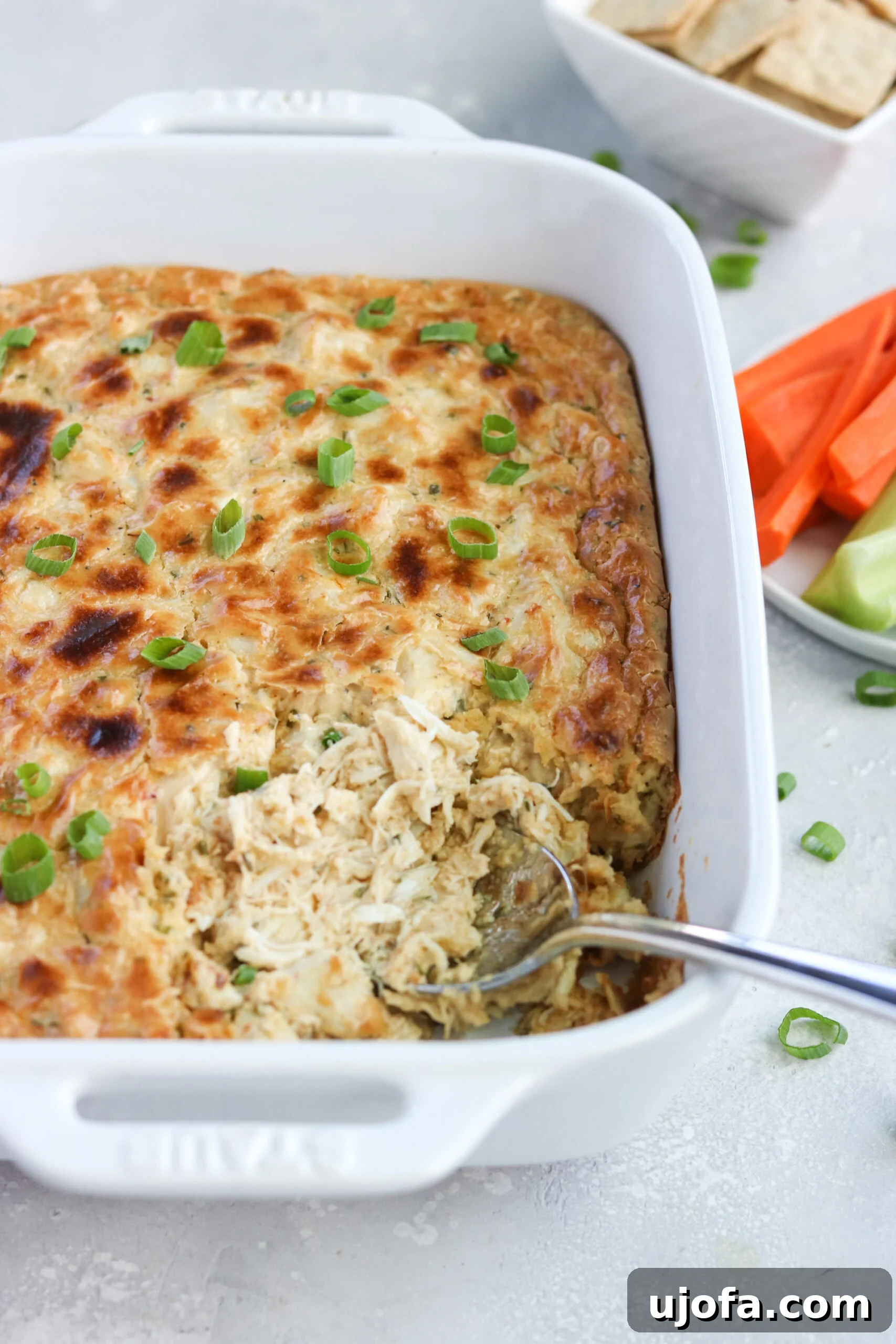 A baking dish filled with the creamy Paleo Maryland Crab Dip mixture, ready for the oven.