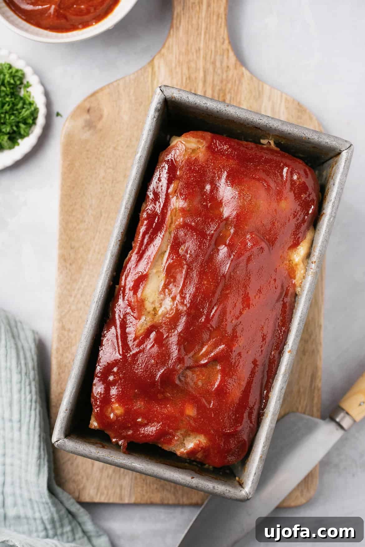 an overhead shot of a meatloaf glazed in a baking pan