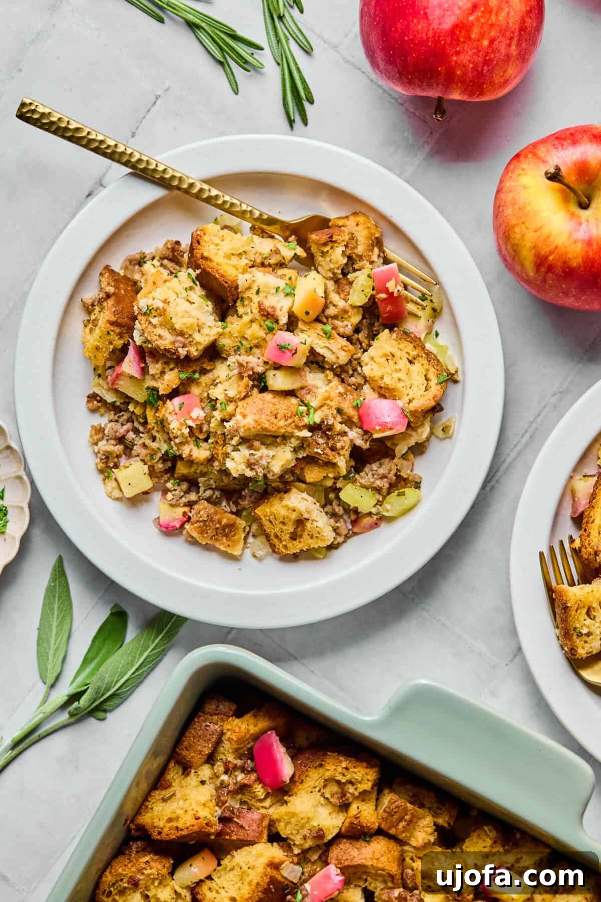 Your New Favorite Gluten Free and Dairy Free Stuffing 11 gluten free stuffing on a plate with a casserole dish near by and apples surrounding it