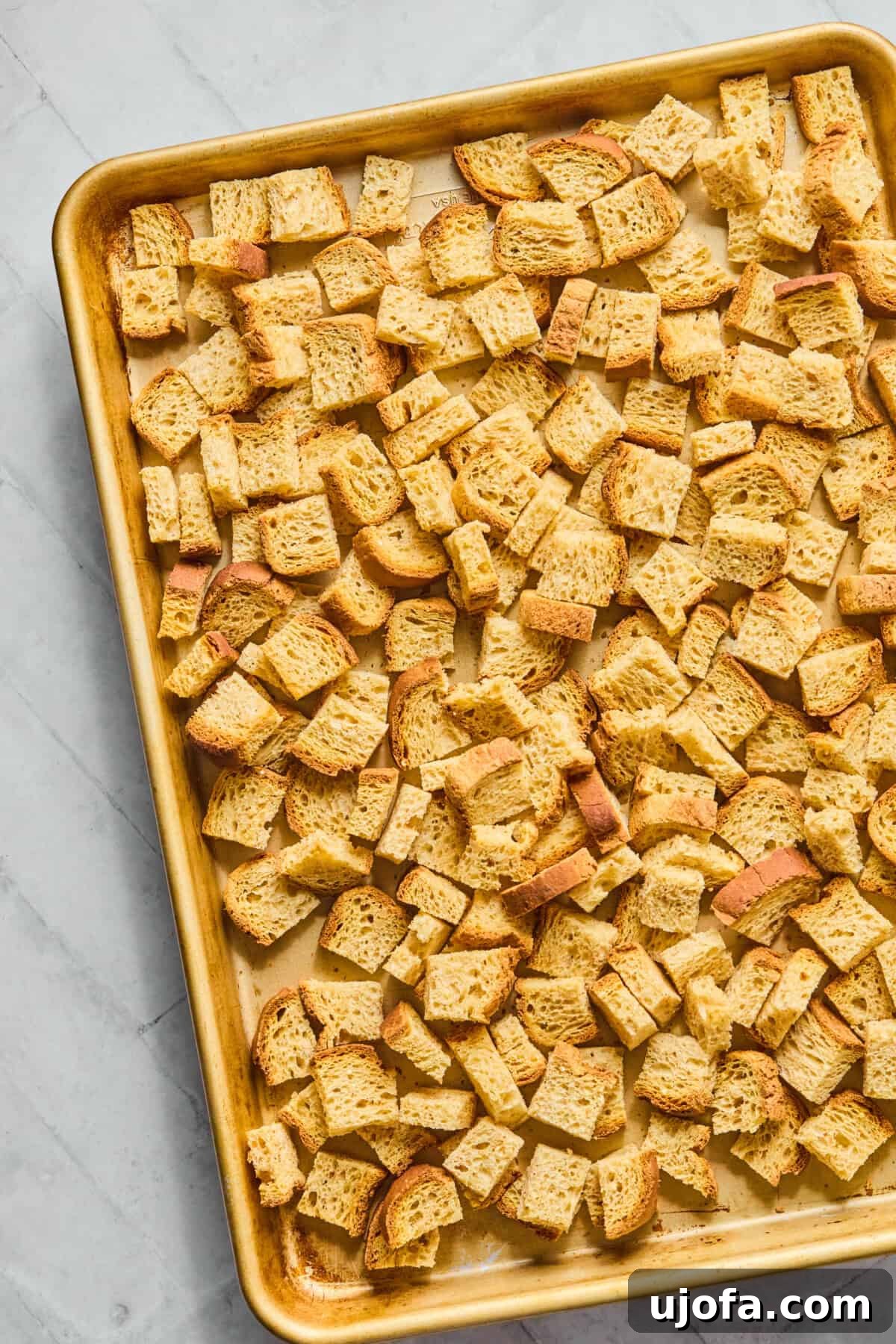 Your New Favorite Gluten Free and Dairy Free Stuffing 4 gluten free bread cubes on a baking pan