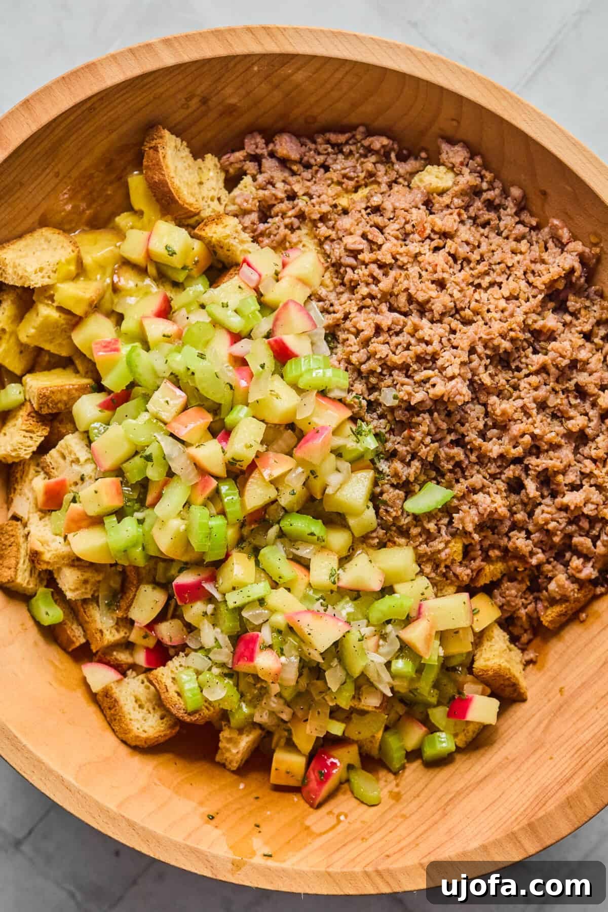 Your New Favorite Gluten Free and Dairy Free Stuffing 7 bread, sausage, and apples and herbs in a bowl