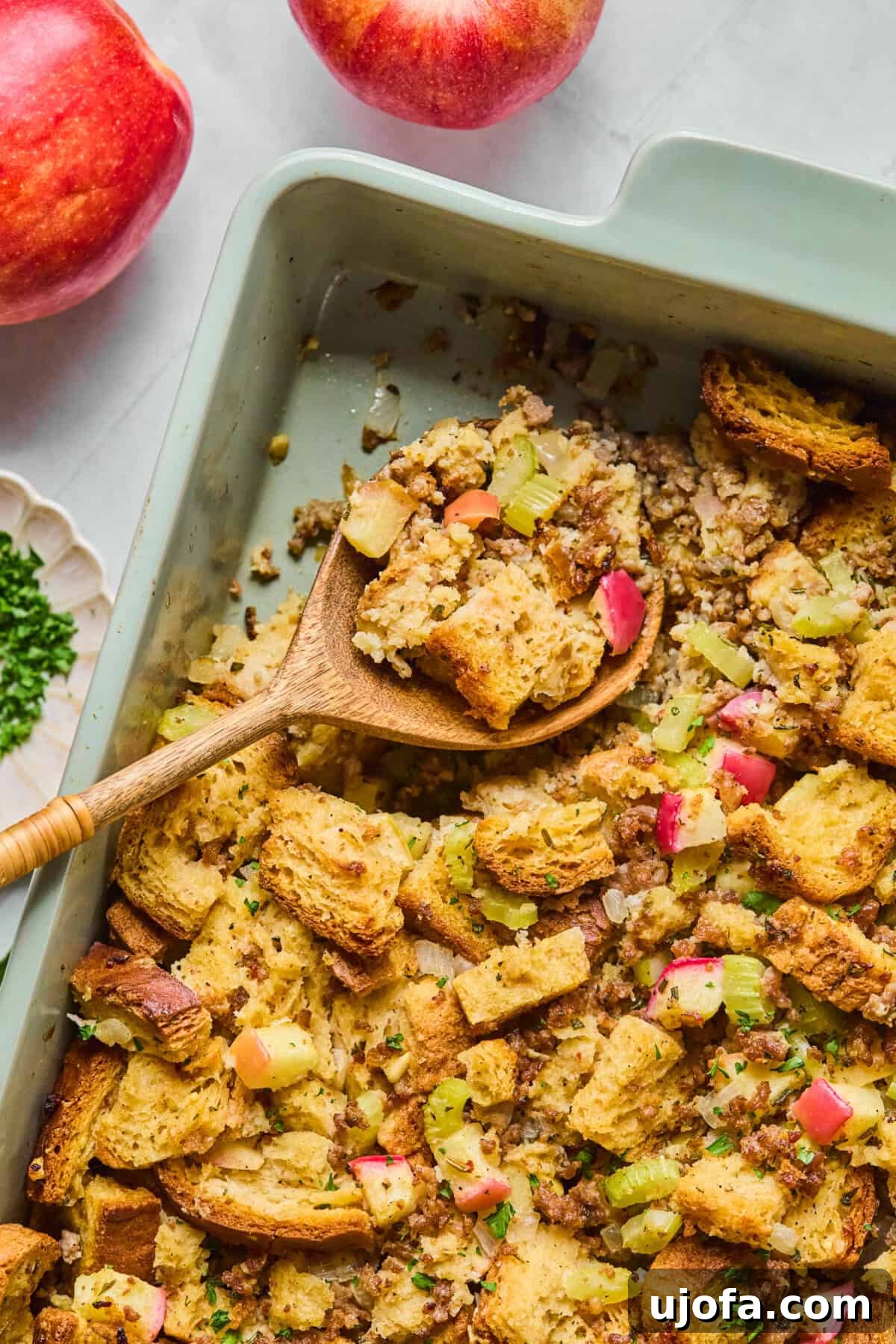 Your New Favorite Gluten Free and Dairy Free Stuffing 10 gluten free stuffing in a casserole dish with a wooden spoon