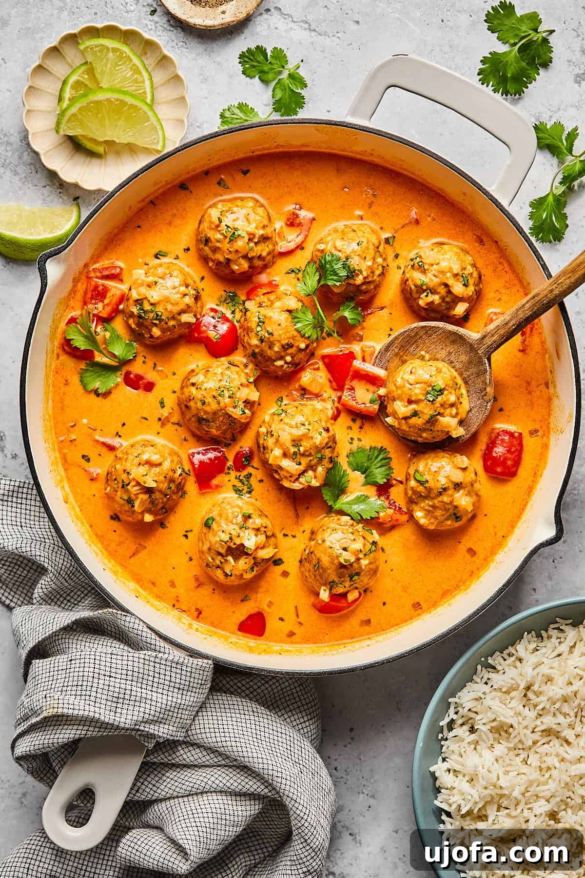 thai turkey meatballs in a skillet with sauce and cilantro on top
