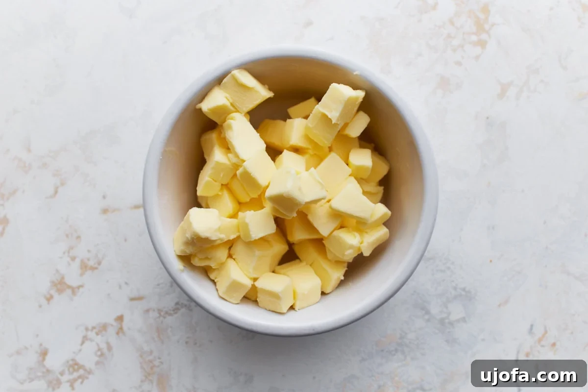 Perfect Gluten-Free Buttermilk Biscuits 5 A white bowl filled with small, firm cubes of cold butter, ready to be incorporated into the biscuit dough.