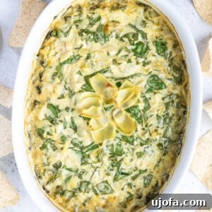 Creamy Dairy-Free Spinach Artichoke Dip made with cashews, served with crisp vegetable sticks